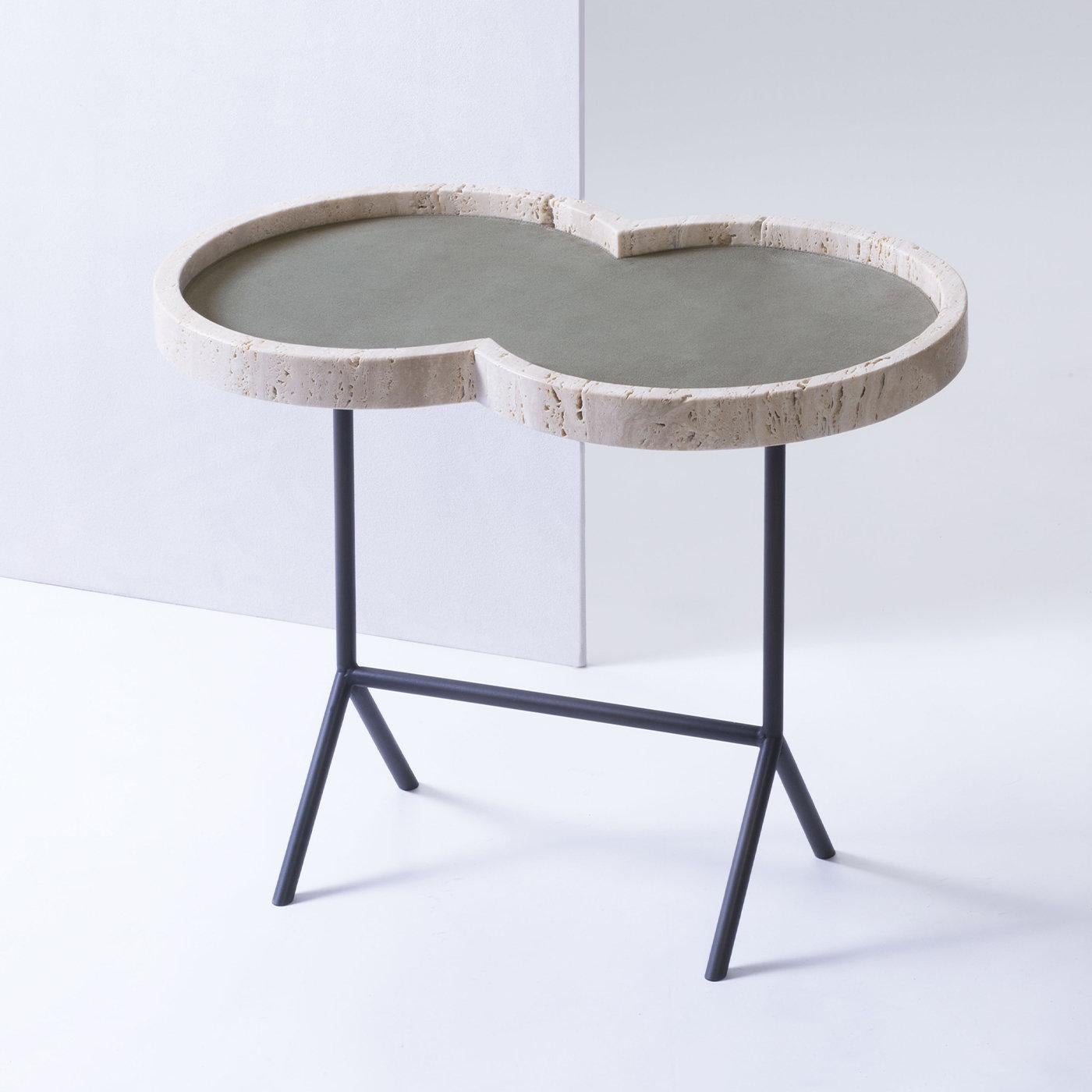 Occasional table with travertine top - Eight by Stephane Parmentier for Giobagnara.
The object presented in the image has following finish: Travertine & A69 Sage Suede Leather (top) and Bronze legs.

Named after the distinctive shape of its top,