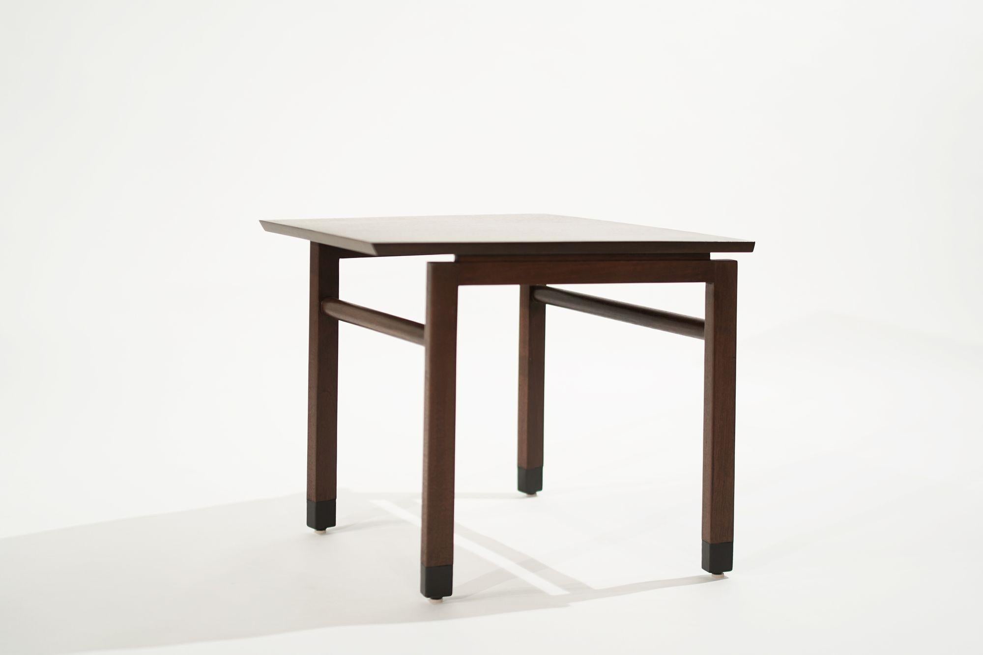 The rarely found Wedge end table designed by Edward Wormely for Dunbar, circa 1950-1959. Executed in walnut, features leather-wrapped feet. completely restored.
 
Other designers from this period include Paul McCobb, Vladimir Kagan, Hans Wegner,