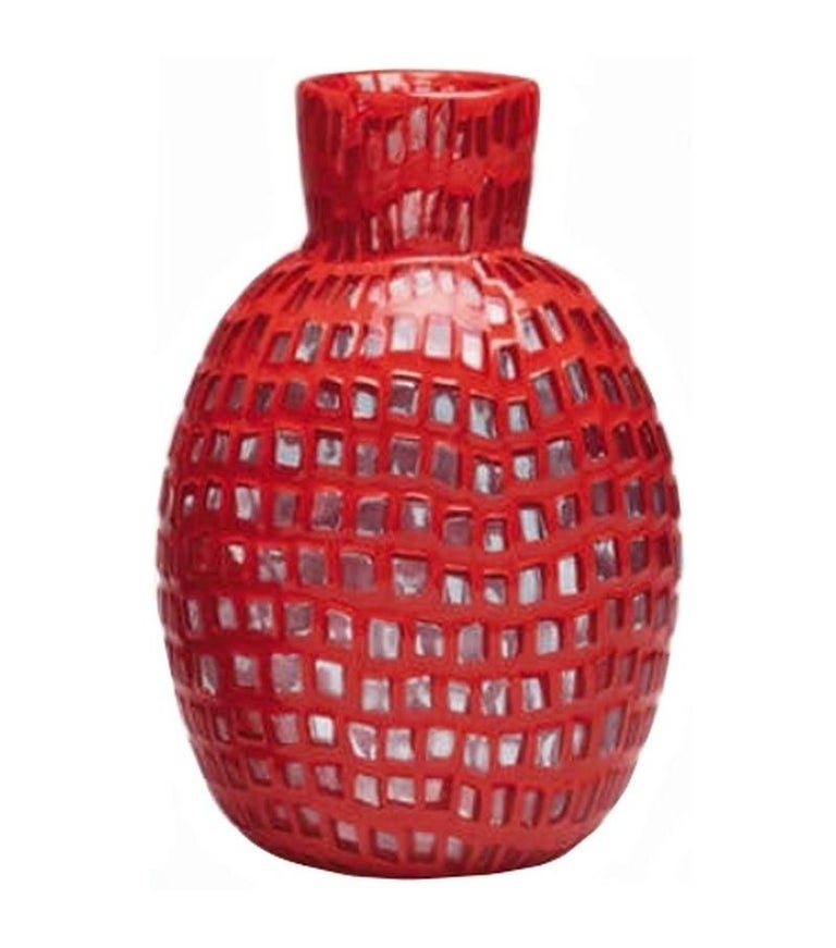 Occhi vase collection, designed by Tobia Scarpa and manufactured by Venini, consists of three different vases made of crystal murrine and coral glass.
Indoor use only.

Dimensions: Ø 14 cm, H 21.5 cm.