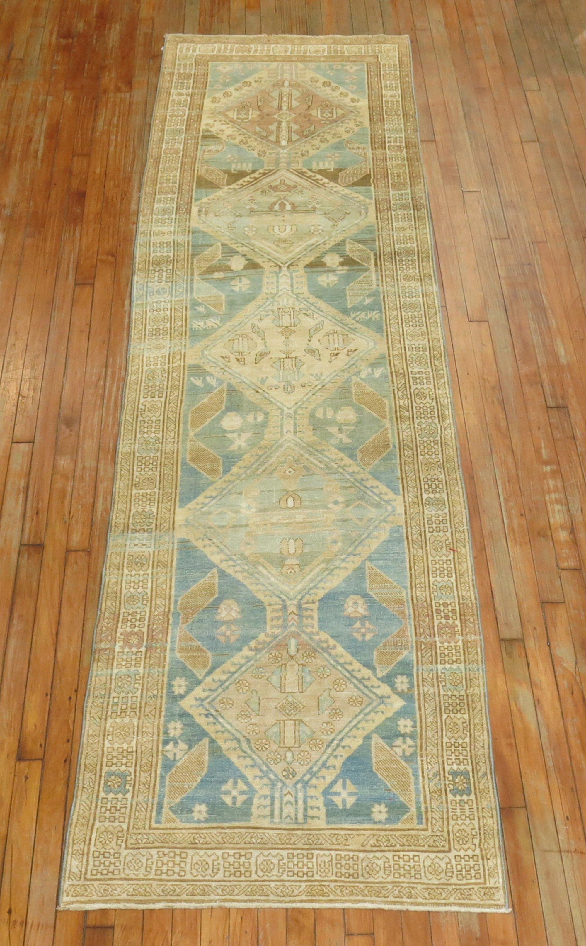 Persian Serab Runner consisting of a ocean blue field with accents in beige, brown and rose, circa 1930.

Measures: 3' x 11'.