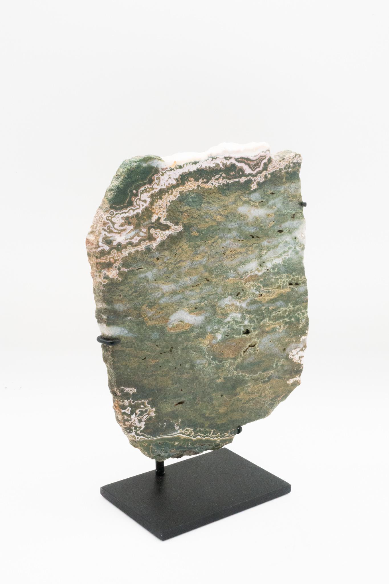 Ocean jasper specimen mounted on a black metal base. Ocean jasper, or snakeskin jasper, is a combination of chalcedony, microcrystalline quartz and other minerals, resulting in colorful bands and patterns.