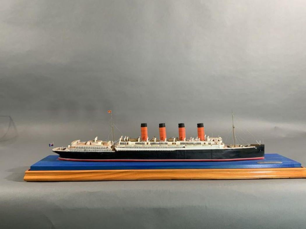 Exceptional model of the famous Cunard four stack liner Mauretania by noted English model maker Ron Hughes. Painted in authentic Cunard livery. Fitted to a glass display case. Weight is 9 pounds. Case dimensions: 9