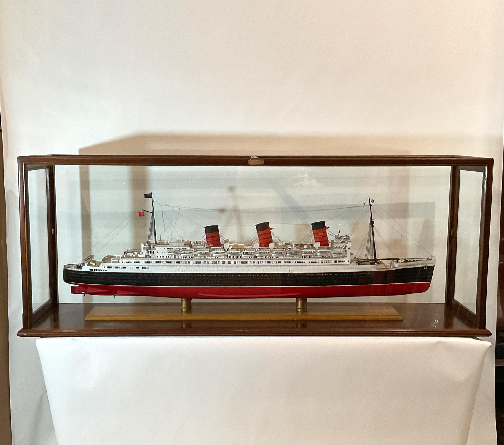 Cased model of the Cunard Lines Ocean Liner “Queen Mary”. Six-foot model of this classic. Highly detailed with planked deck, cabins, skylights, lifeboats, steam funnels, ventilator funnels, etc. Fitted to a custom mahogany case.

Weight: 170