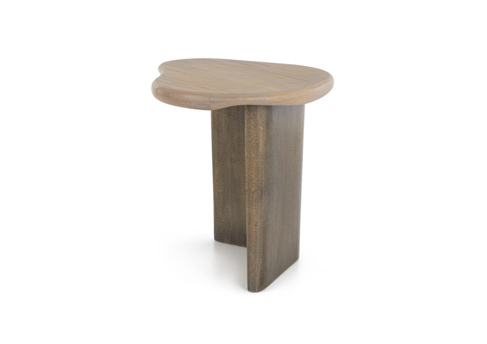 Ocean, a side table inspired by the ever-changing beauty of ocean waves. Its fluid, amorphous shape captures a sense of organic beauty, making it a simple yet captivating statement for any space. The table's top, constructed from solid oak, adds a