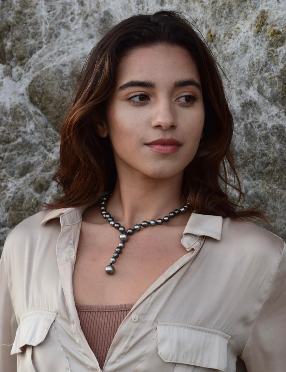 The Oceana Strand is a fresh take on the classic pearl necklace, featuring round 8mm pastel Tahitian pearls accented by two luminous 11mm Tahitian pearls at the base. A graceful center strand cascades down the chest, adding movement and stylish