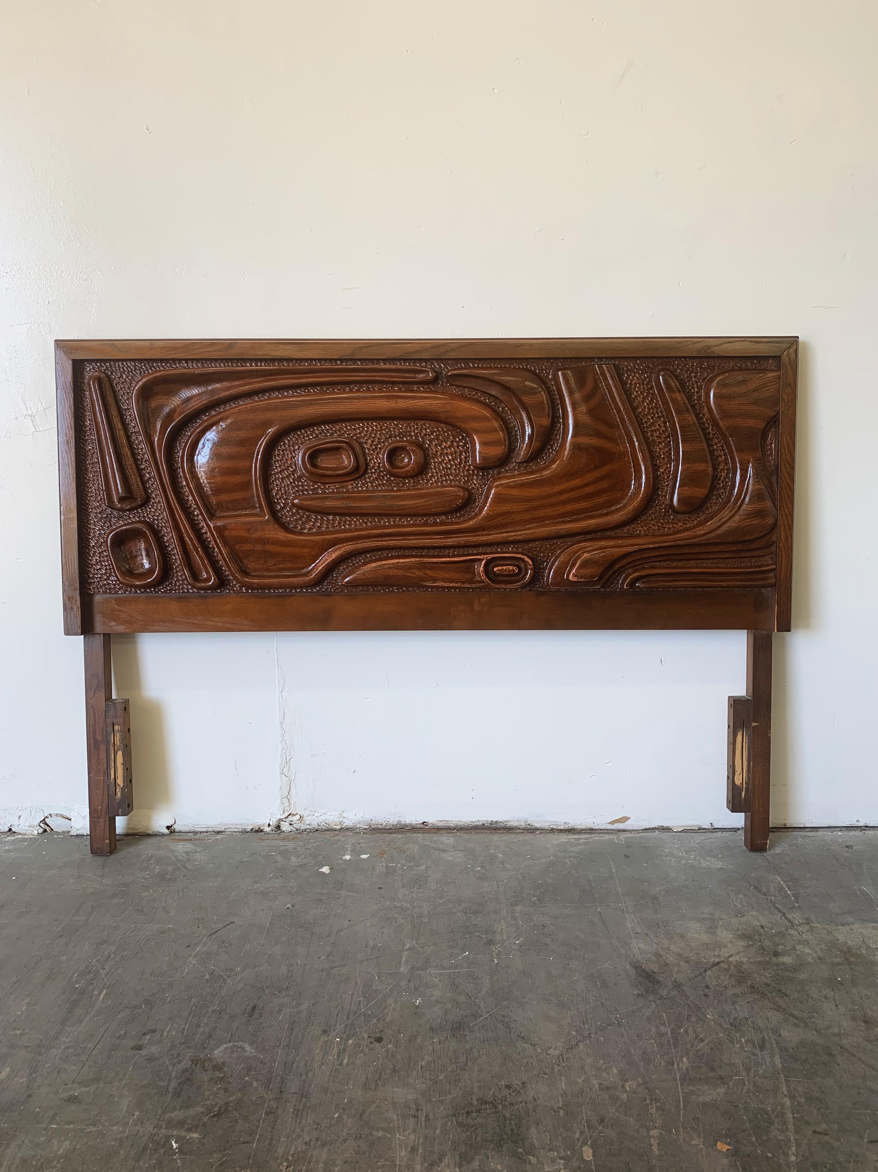 This fantastic lacquered sculpted walnut 'Oceanic' headboard by Pulaski Furniture Corporation, circa 1969 which perfectly encapsulates the California surf mentality of the 1960s and 1970s, making this piece a highly sought after design by Tiki