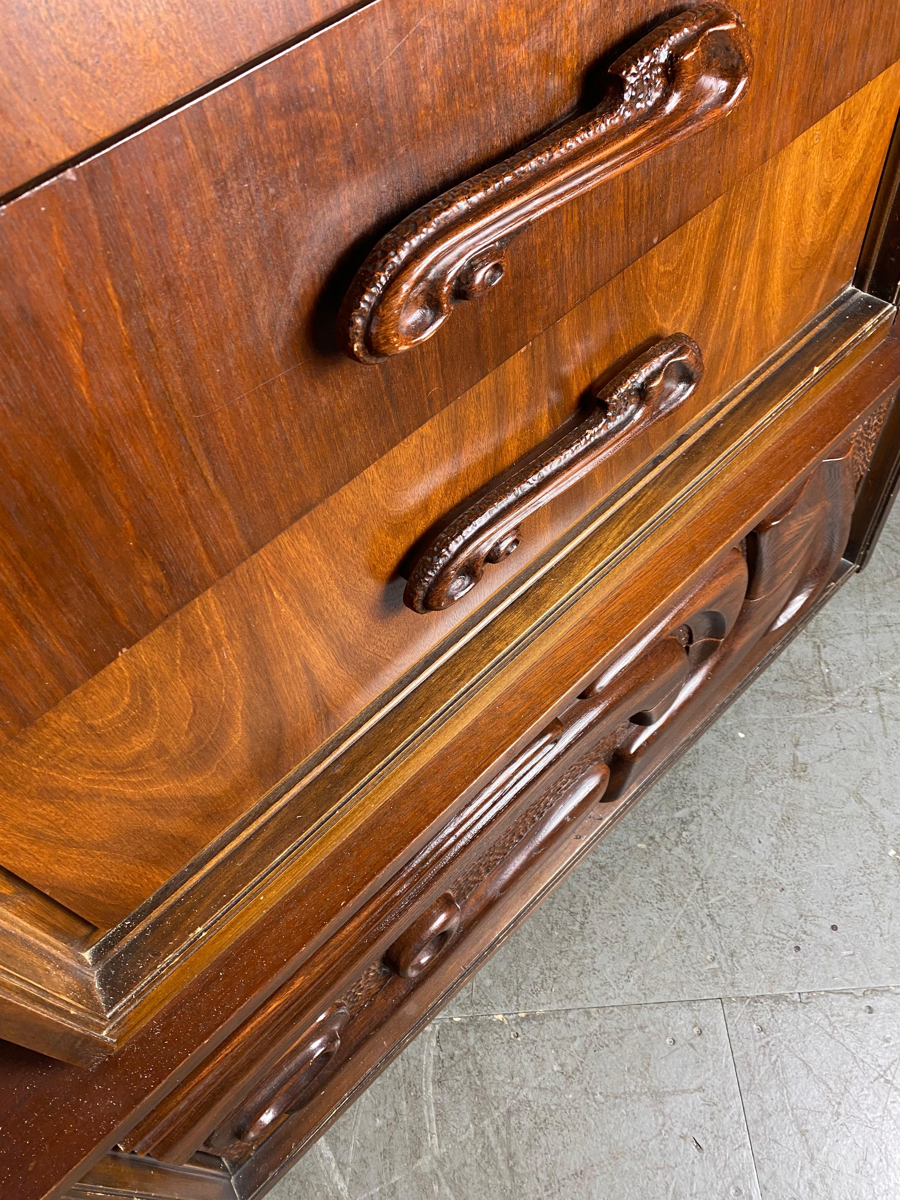 This lovely rare oceanic contour highboy gentlemen’s dresser is by Pulaski Furniture Co is often attributed to Witco. The credenza of this line by Pulaski Furniture Corporation was featured in Donald Draper's office for multiple seasons on the hit