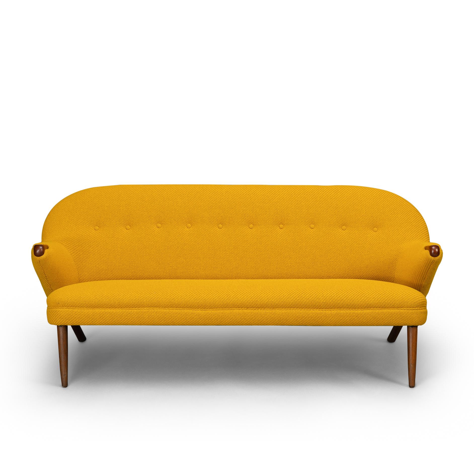 Edgy Johannes Andersen 2.5-seat sofa for CFC Silkeborg sofa in stunning new upholstery. The sofa has a super soft look with solid teak paws and legs. Springed seating is taken from the original design and the sofa is reupholstered with Kvadrat Coda