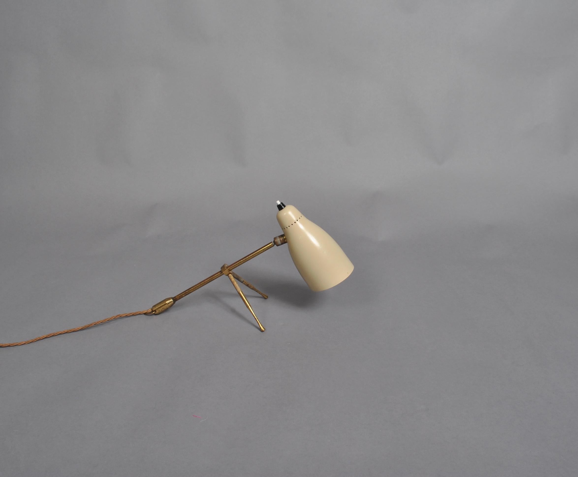 The Ochetta midcentury table or wall lamp by Guiseppe Ostuni for O-Luce, Milan, Italy, 1950s
Sand color shade on brass stem and legs. Adjustable head.

Newly rewired.