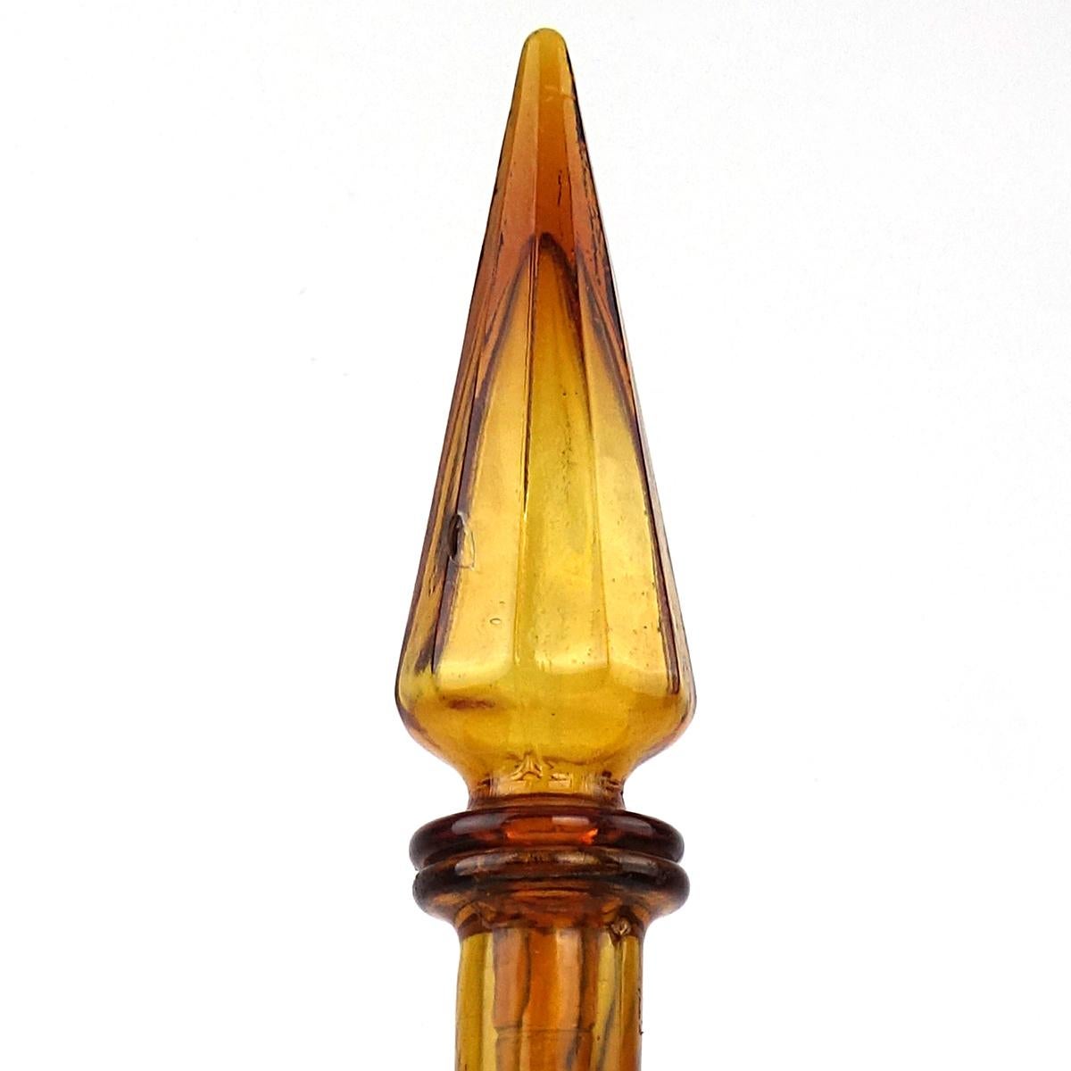 Sleek midcentury ochre glass decanter with stopper.
The design by Empoli is called Genie.