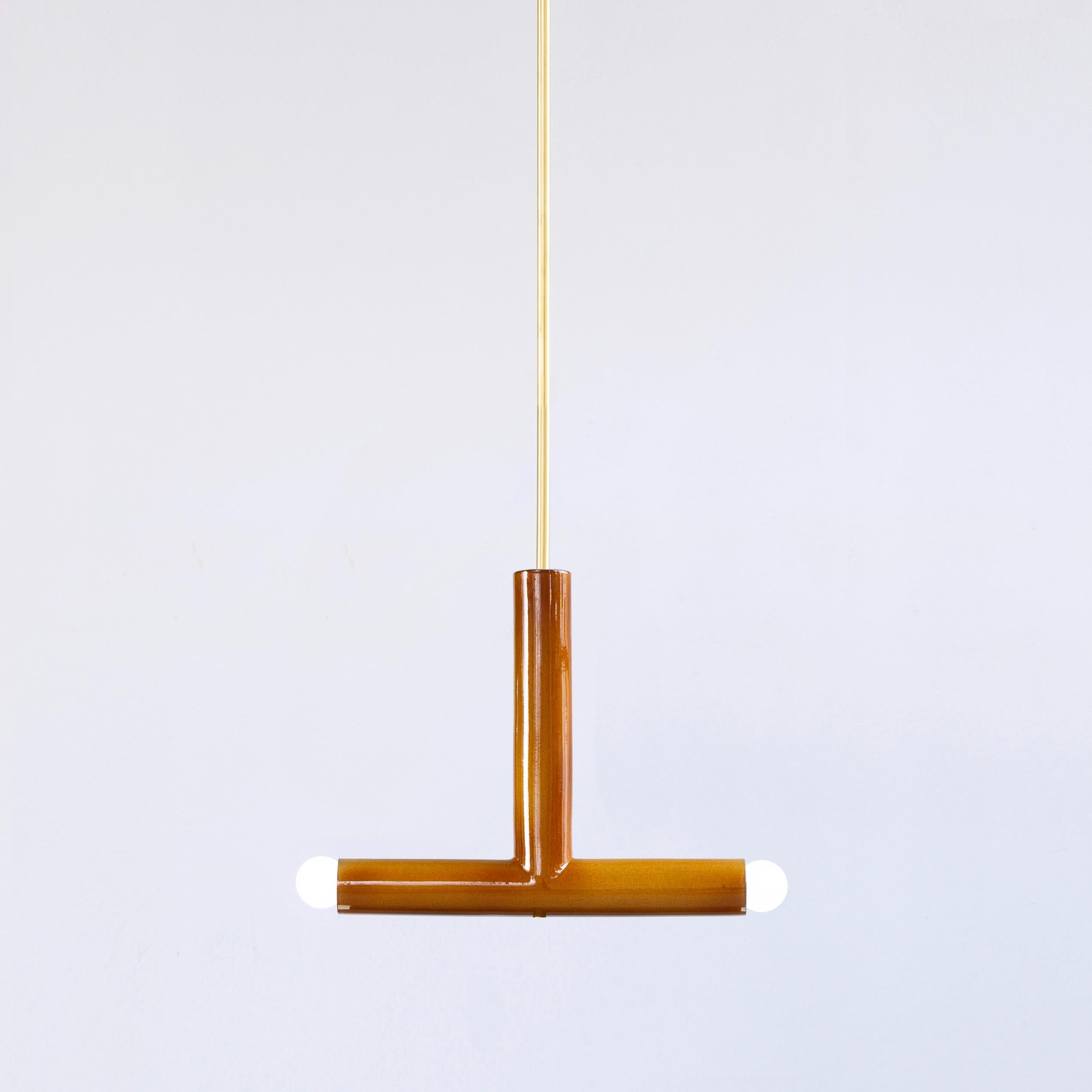 Ochre TRN B2 pendant lamp by Pani Jurek
Dimensions: D 5 x W 35 x H 30 cm 
Material: Hand glazed ceramic.
Available in other colors.
Lamps from the TRN collection hang on a metal tube, not on a cable. This allows the lamp to be mounted in a specific
