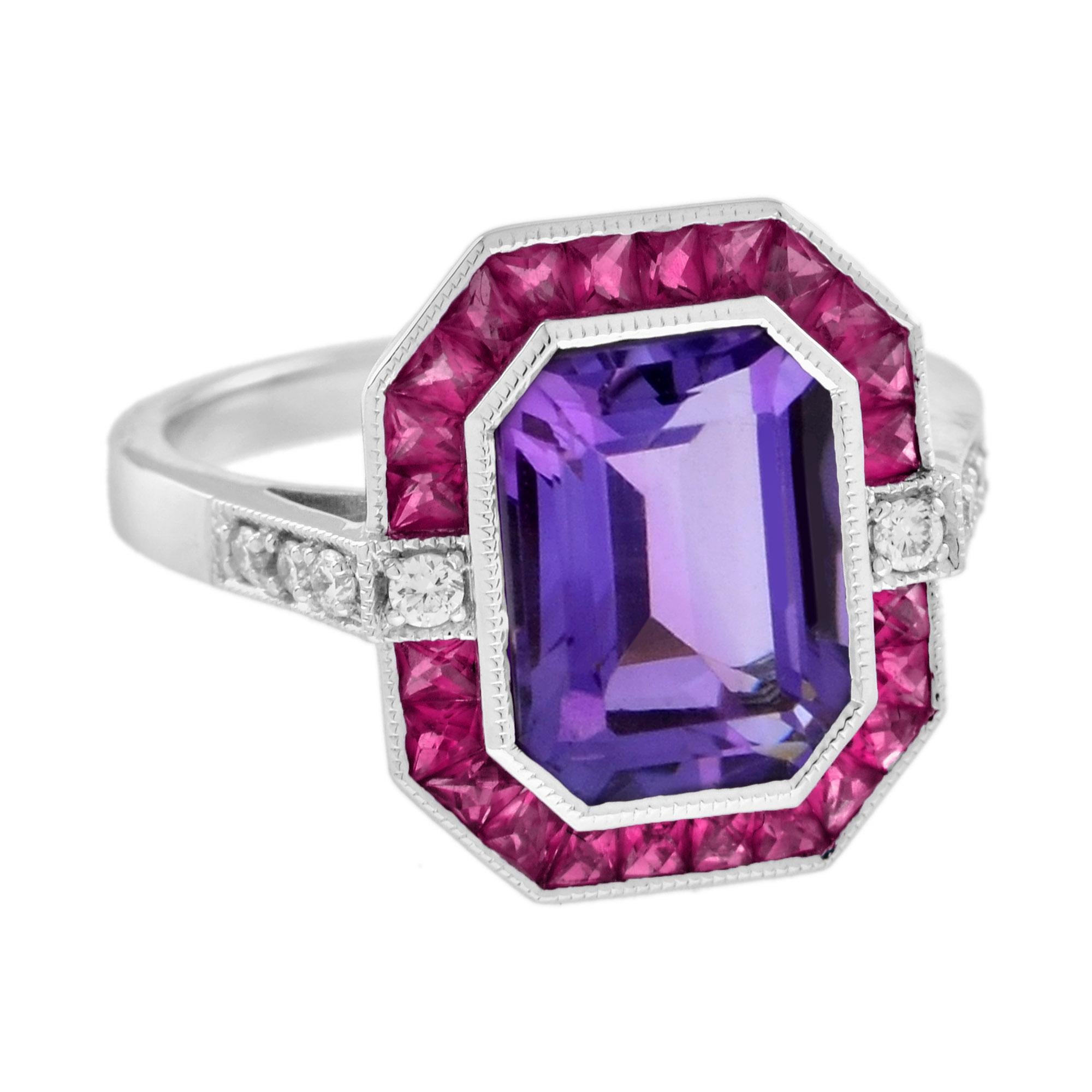 A striking and intriguing jewel, indeed. This bold and colorful Art Deco style ring highlights a gorgeous gleaming emerald cut amethyst framed in eye-catching contrast by French cut rubies. Each side and shoulders set off with round diamond with