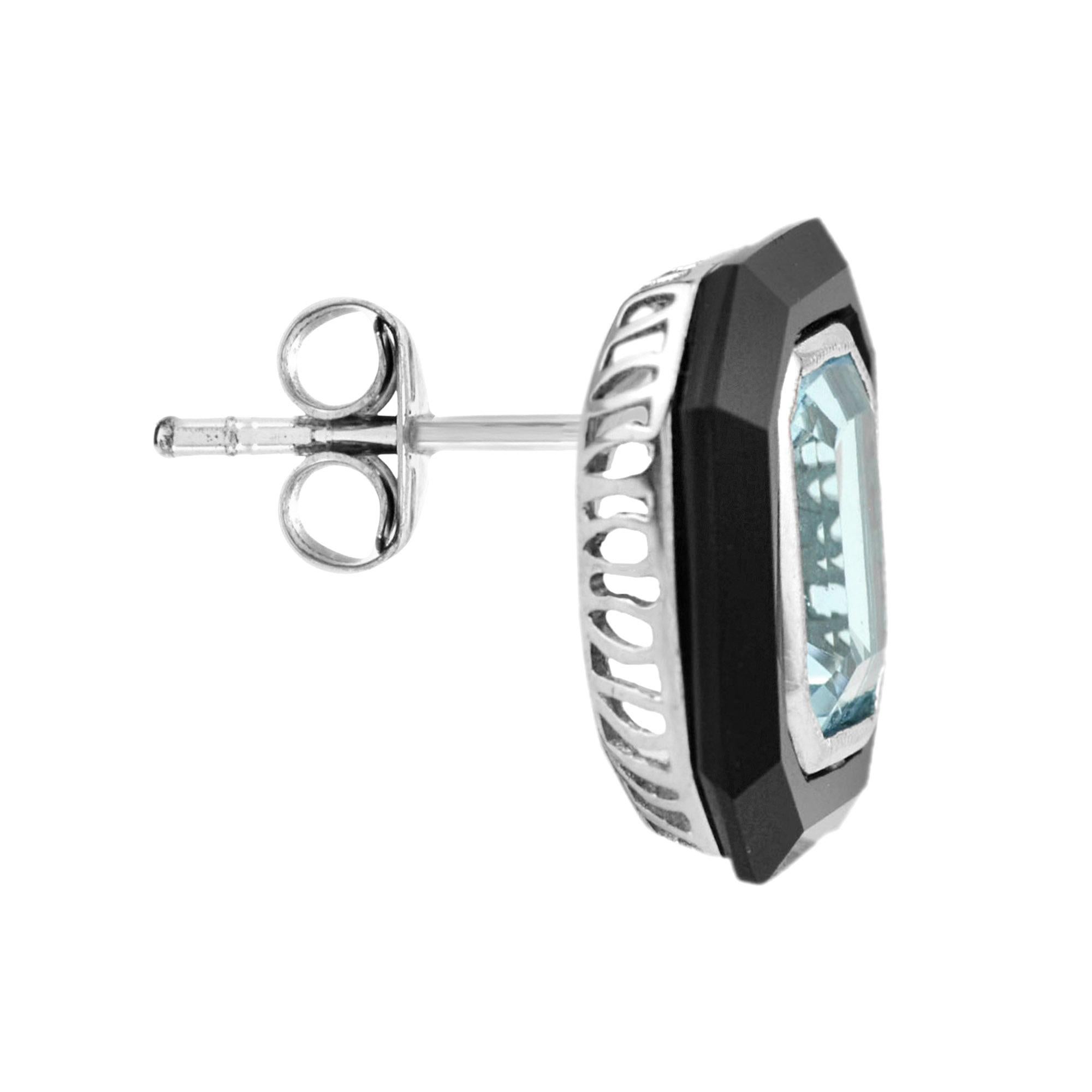 With radiant sparkle and bold contrast, these stud earrings are irresistible. Each features an emerald cut sky blue topaz, edged in outer frame of black onyx. 14K White Gold. 
Information
Style: Art Deco
Width: 14 mm.
Length: 15 mm.
Weight: 10.87 g.