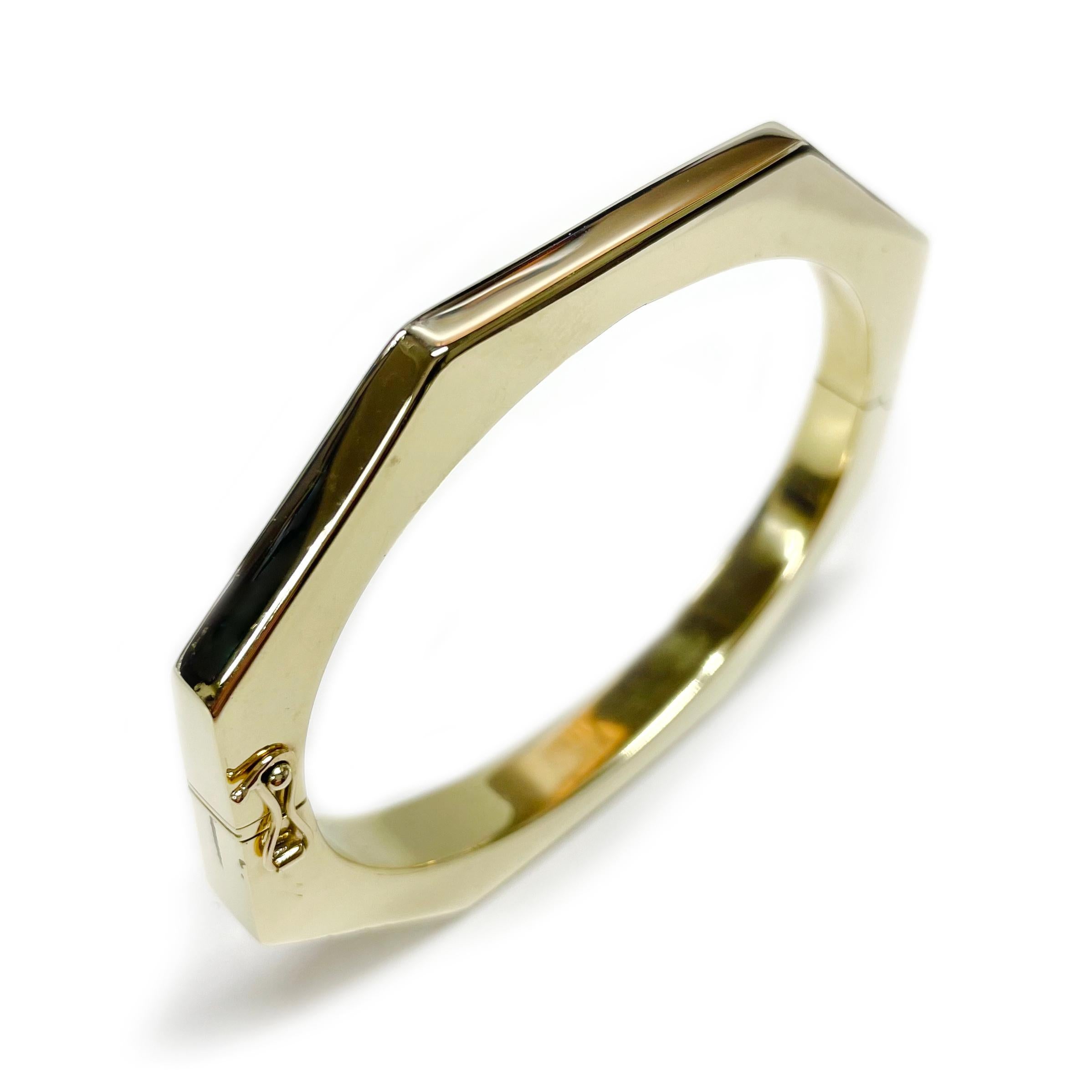 14 Karat Octagon Hinged Bangle Bracelet. The bangle bracelet is eight-sided with high-polish and box closure with safety-eight. The bracelet measures 69.90 x 60.90 x 7.8mm and tapers in width from the front of the bangle to the back from 7.8 to