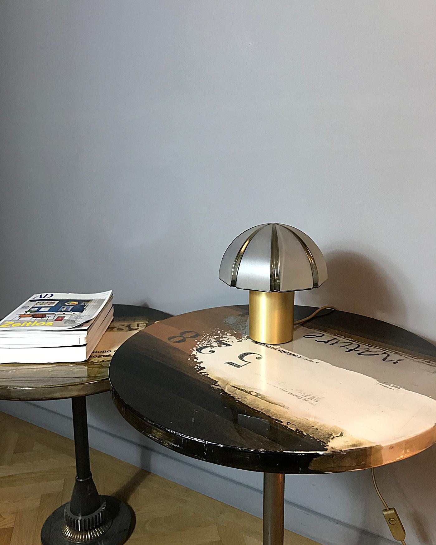 Elegant space age table lamp manufactured by Peill & Putzler in Germany. The lamp features a brass base with a mouth-blown lampshade in octagon cut that provides smooth and wonderful light. The lamp is in excellent condition. 
Fully working rewired