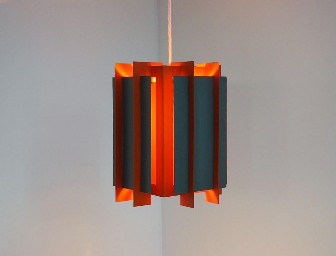 Pendant called octagon made in painted metal and it is made by an unspecified designer for Lyfa in the 1960s.

It was made in different colors and here it is in orange and gray, but it was also made in purple, red and yellow. The model name refers
