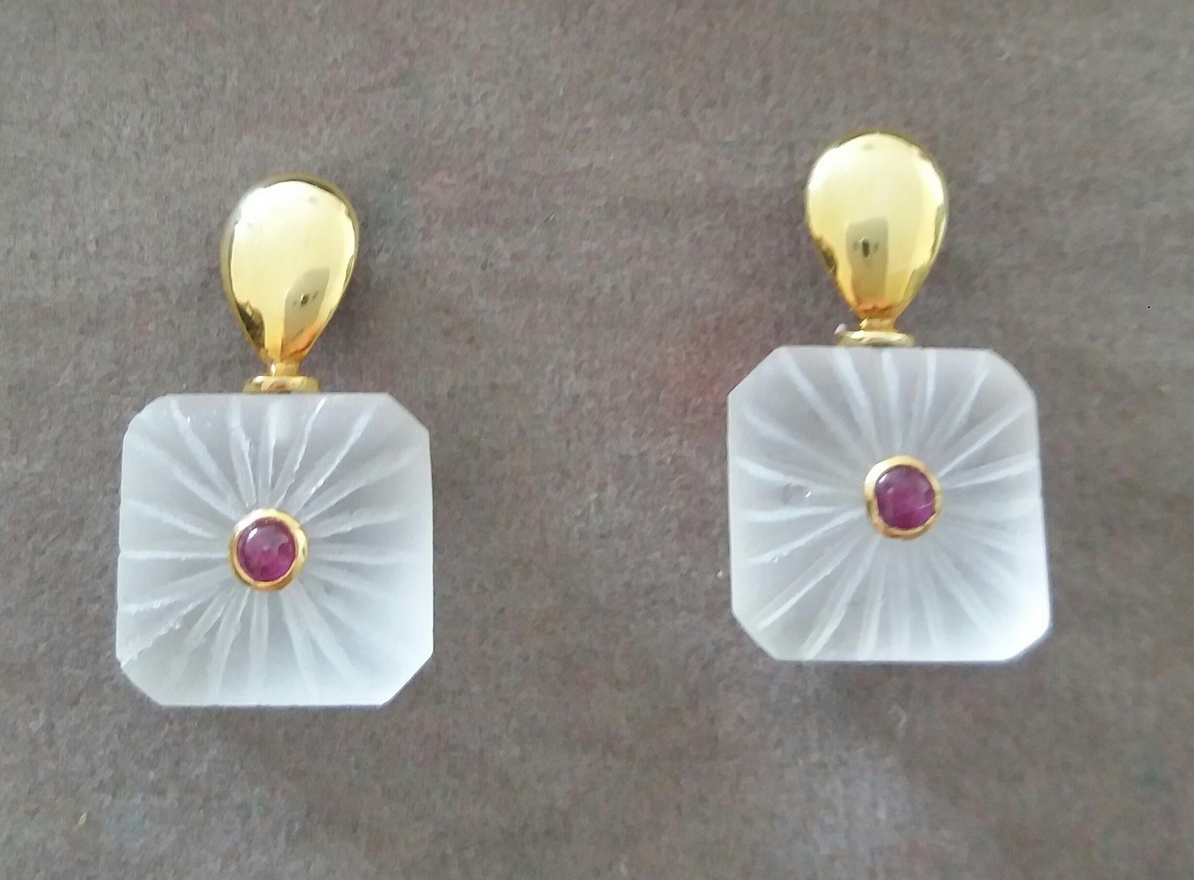 Simple Chic Earrings  made of 2 Engraved Octagon Shape Rock Crystals measuring 13 x 13 mm with 2 small round Ruby cabs set in yellow gold, suspended from 2 plain yellow gold elements in a flat drop shapes.

In 1978 our workshop started in Italy to