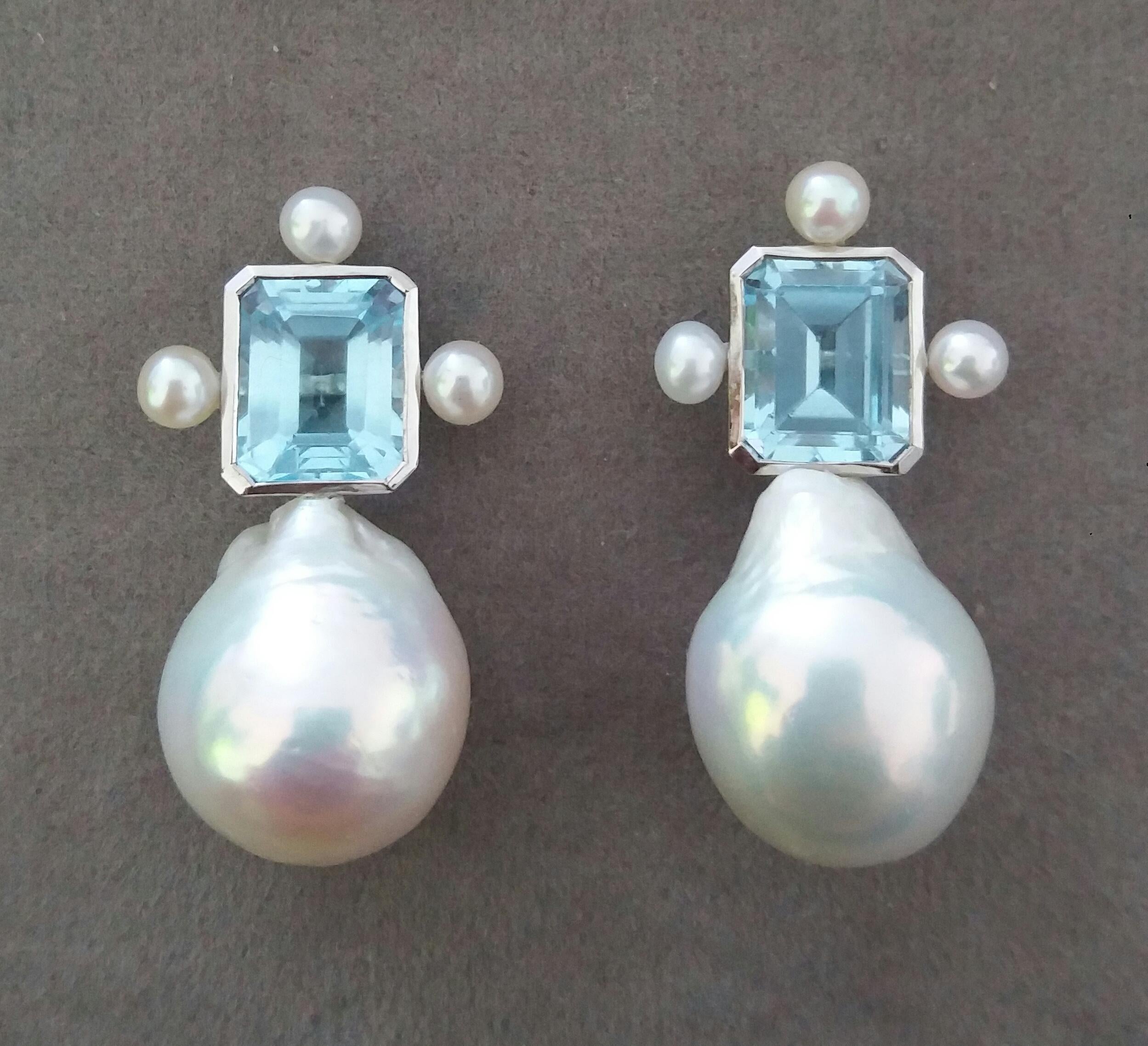 These elegant and handmade earrings have 2 Octagon Faceted Sky Blue Topaz measuring 9 x 11 mm set in a 14 Kt white gold bezel with 3 small round pearls of 4mm on 3 sides at the top to which are suspended 2 very good luster White Pear Shape Baroque