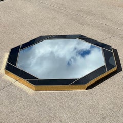 Octagon-shaped aperture mirror with an acrylic brass and black frame