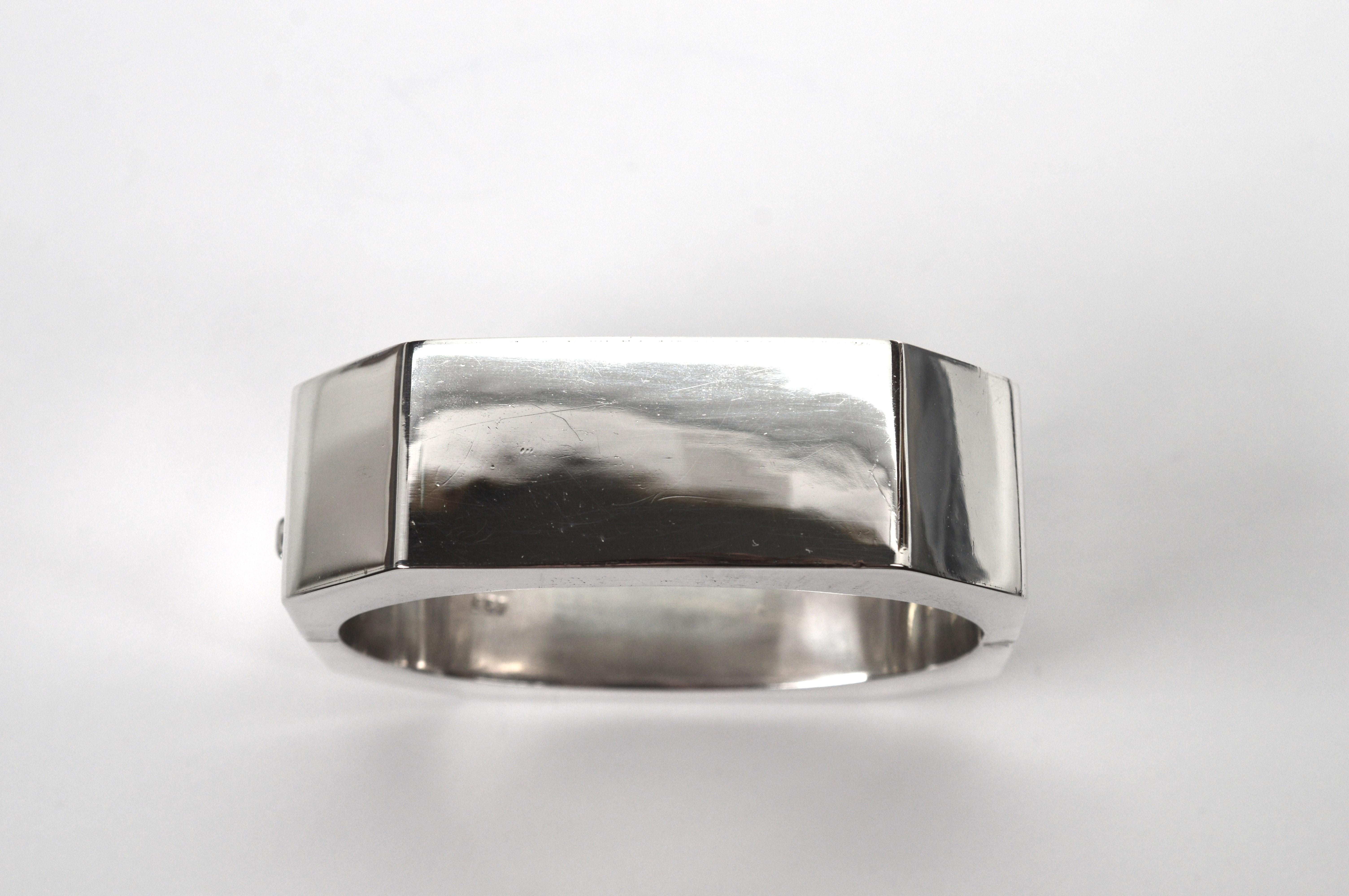 Geometrically contoured with eight angled sides in .925 sterling silver, this interesting vintage bangle bracelet with its bright finish, is a generous 3/4 inch wide. Great for stacking or as a singular piece. This quality silver bracelet is
