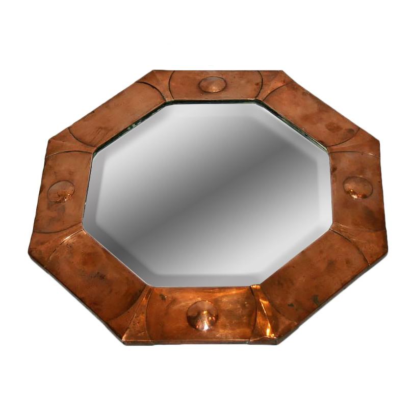 A circa 1930s French Art Deco octagonal copper mirror with beveled glass.

Measurements:
Diameter 17