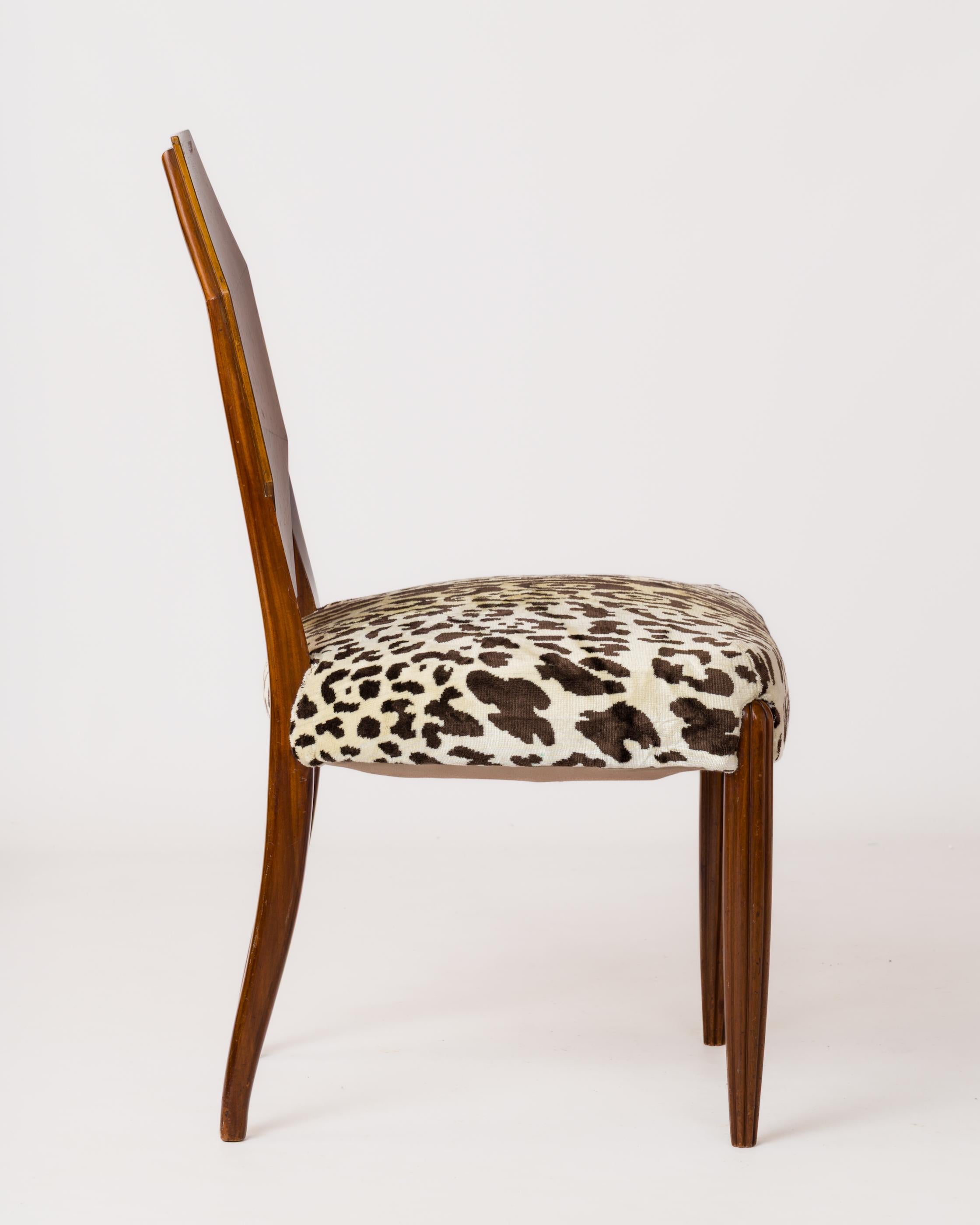 French Art Deco Chair attributed to DIM (Décoration d'Intérieur Moderne). Curved back in mahogany marquetry in an octagonal shape. Carved wooden front legs, new upholstery, imitation leopard Dedar fabric.
This chair will ship from France and can be