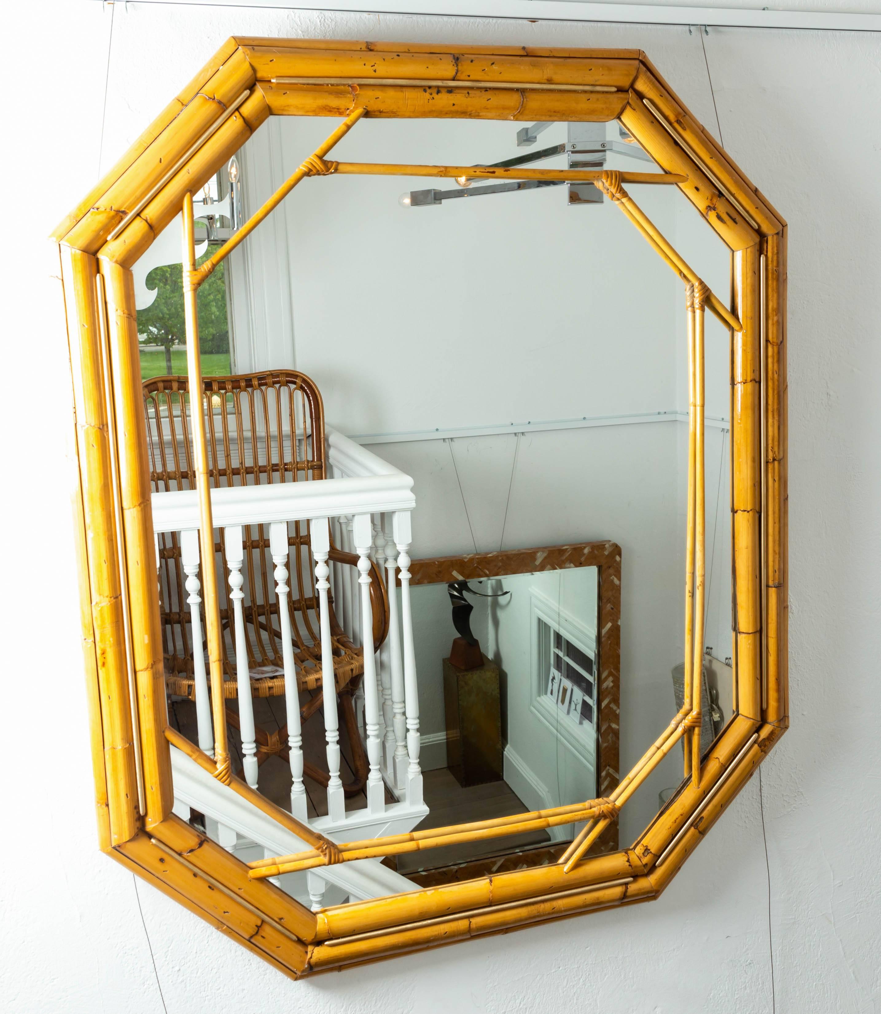 Octagonal bamboo surround mirror with brass details.