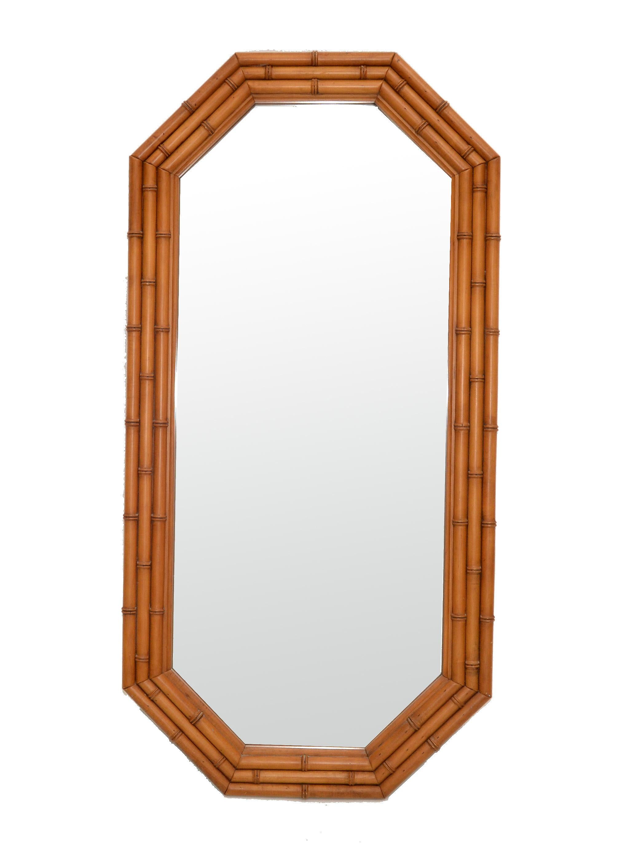 1950s Bohemian Chic octagonal wall or dresser mirror made out of bamboo. 
The mirror is heavy and is supported by a wooden backing for secure hanging.
American craftsmanship in it's best.
Mirror Size: 17 x 41.5 inches.
Can be used as single wall