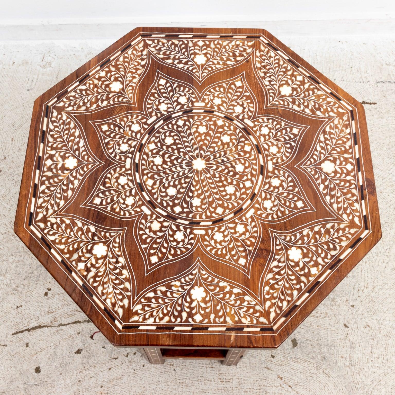 A teak and bone inlaid Moorish style side table with central star medallion on the tabletop.
