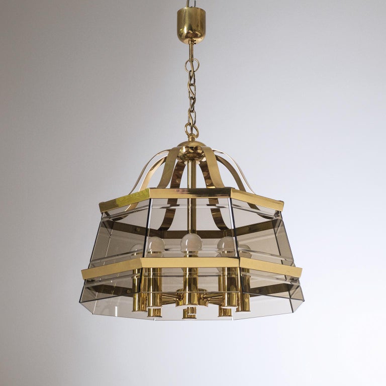 Impressive brass and smoked glass lantern or chandelier from the 1980s. Octagonal brass structure with eight smoked and cut glass planes. Good original condition with minor patina and eight E14 sockets. Height without chain is 17inches/43cm.