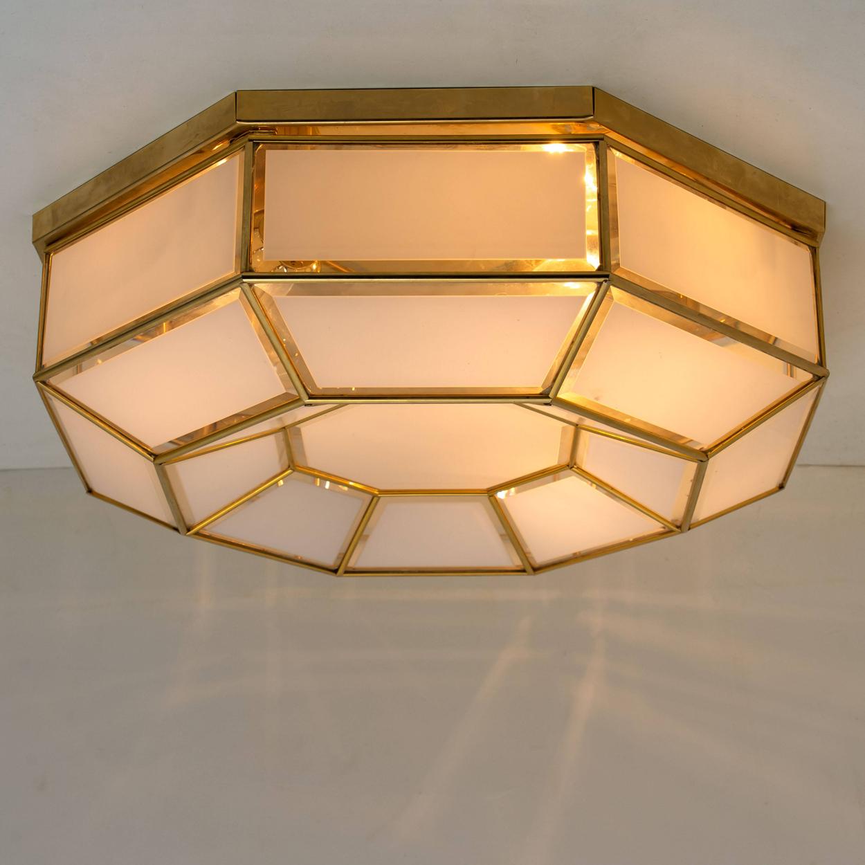 This beautiful and unique octagonal glass light flush mount or wall light is manufactured in Germany during the 1970s, (early 1970s). Nice craftsmanship. Minimal, geometric and simply shaped design. Opal glass with brass frame.

Designed as