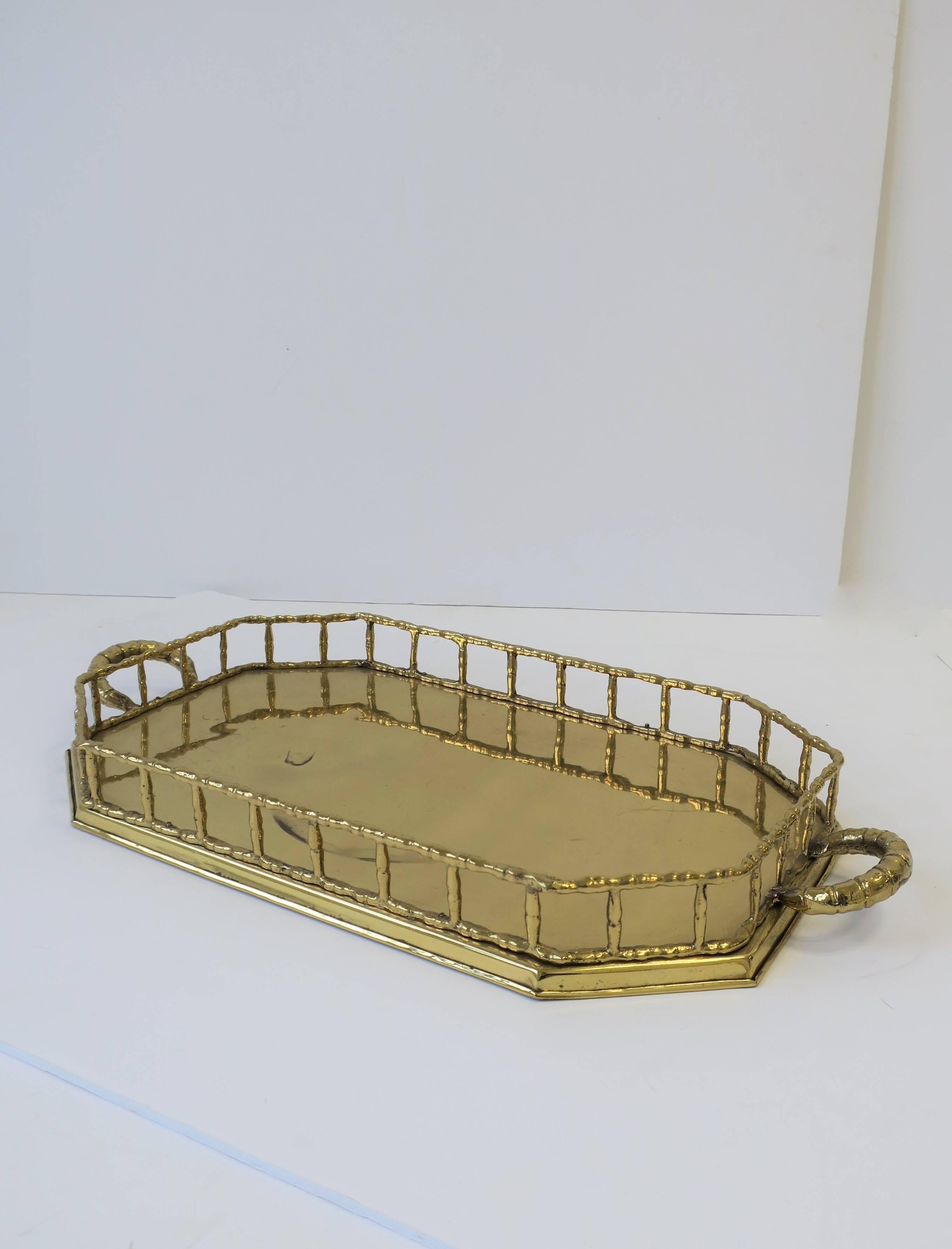 A beautiful vintage octagonal brass tray with decorative 'bamboo' style edge and handles. 

Tray measures: 20.75 in. W x 10 in. D x 2 in. H

