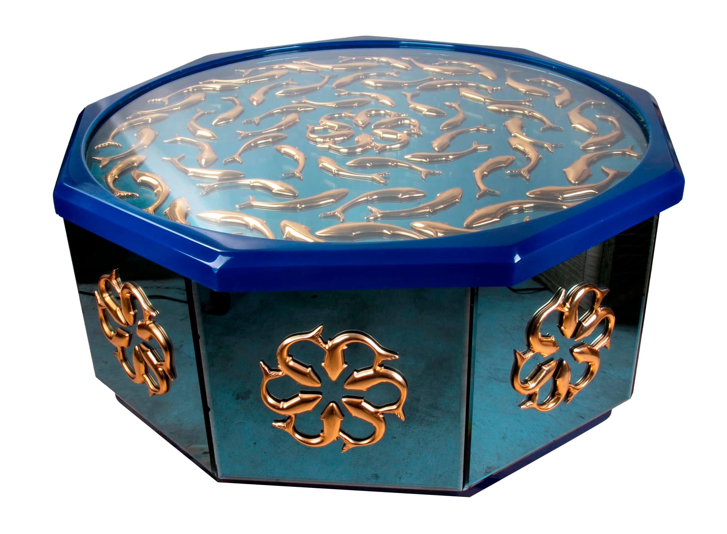 Octagonal brass table with glass, fish decoration and glass top.