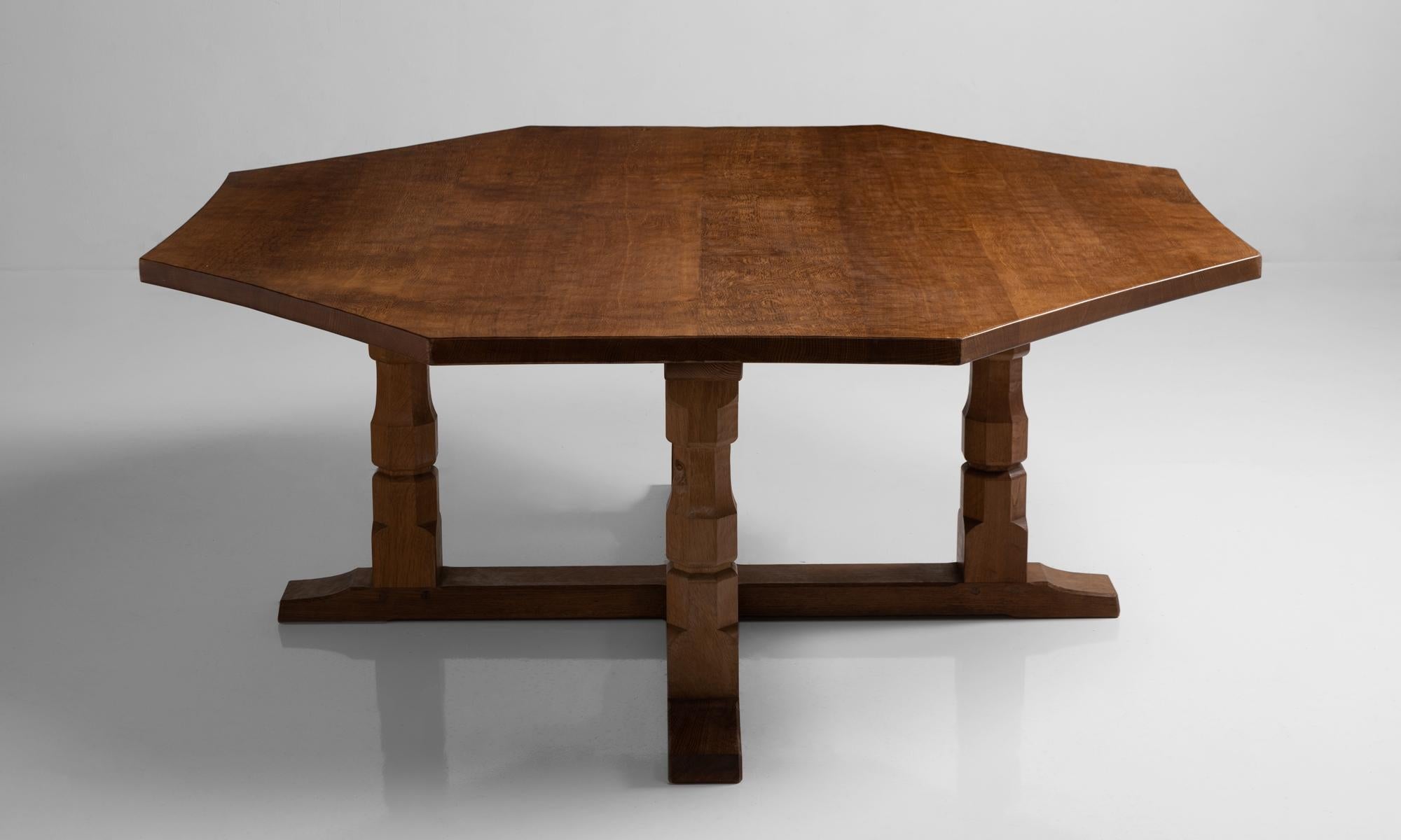Octagonal centre table by Robert “Mouseman” Thompson, England, circa 1950.

Solid oak construction with scalloped top and carved mouse relief.