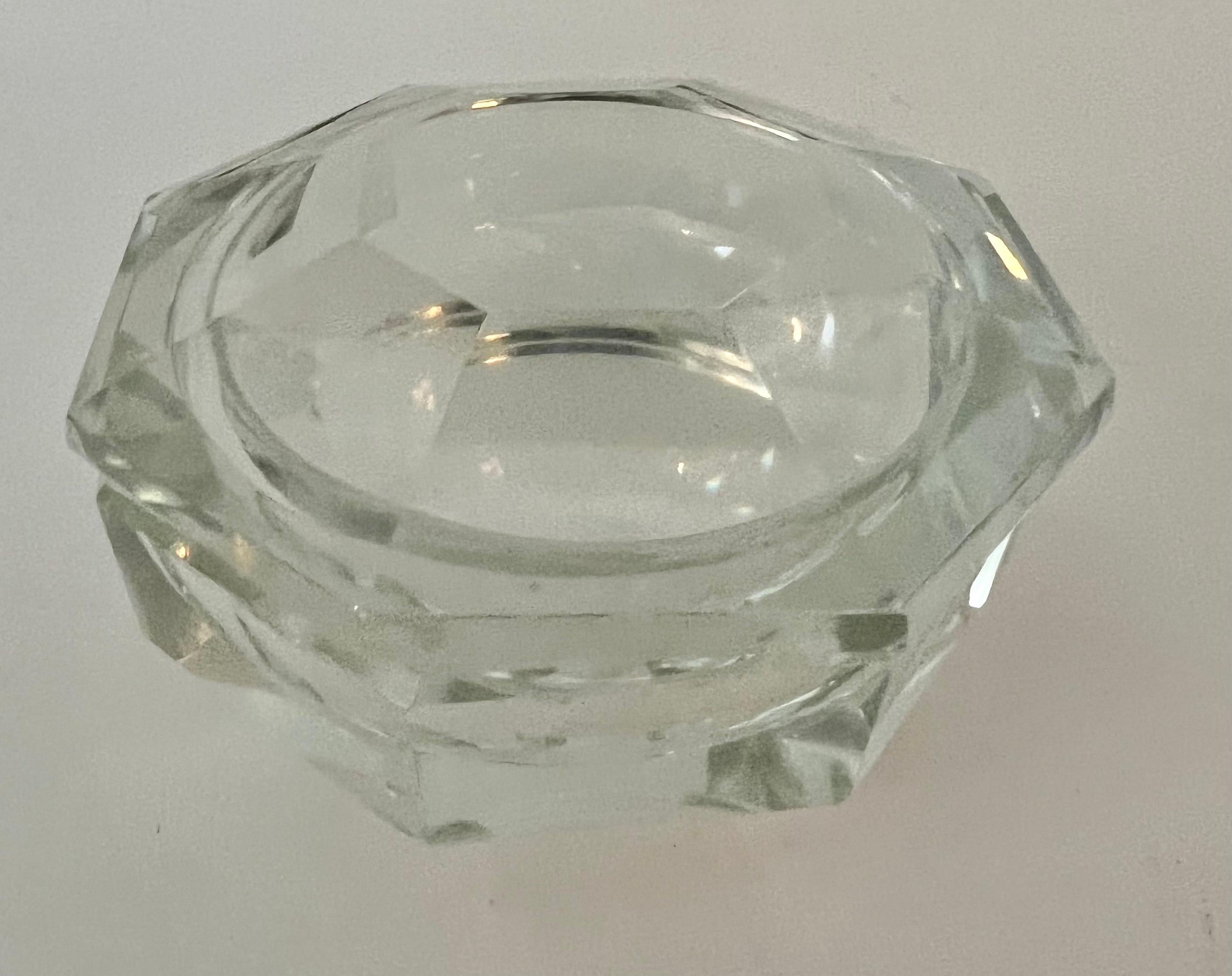 An octagonal crystal bowl with an octagonal lid. A very unique design and a compliment to any cocktail table - the piece is a nice decorative item or works well as a bowl for candy and nuts. Also works well on a desk or work station.
