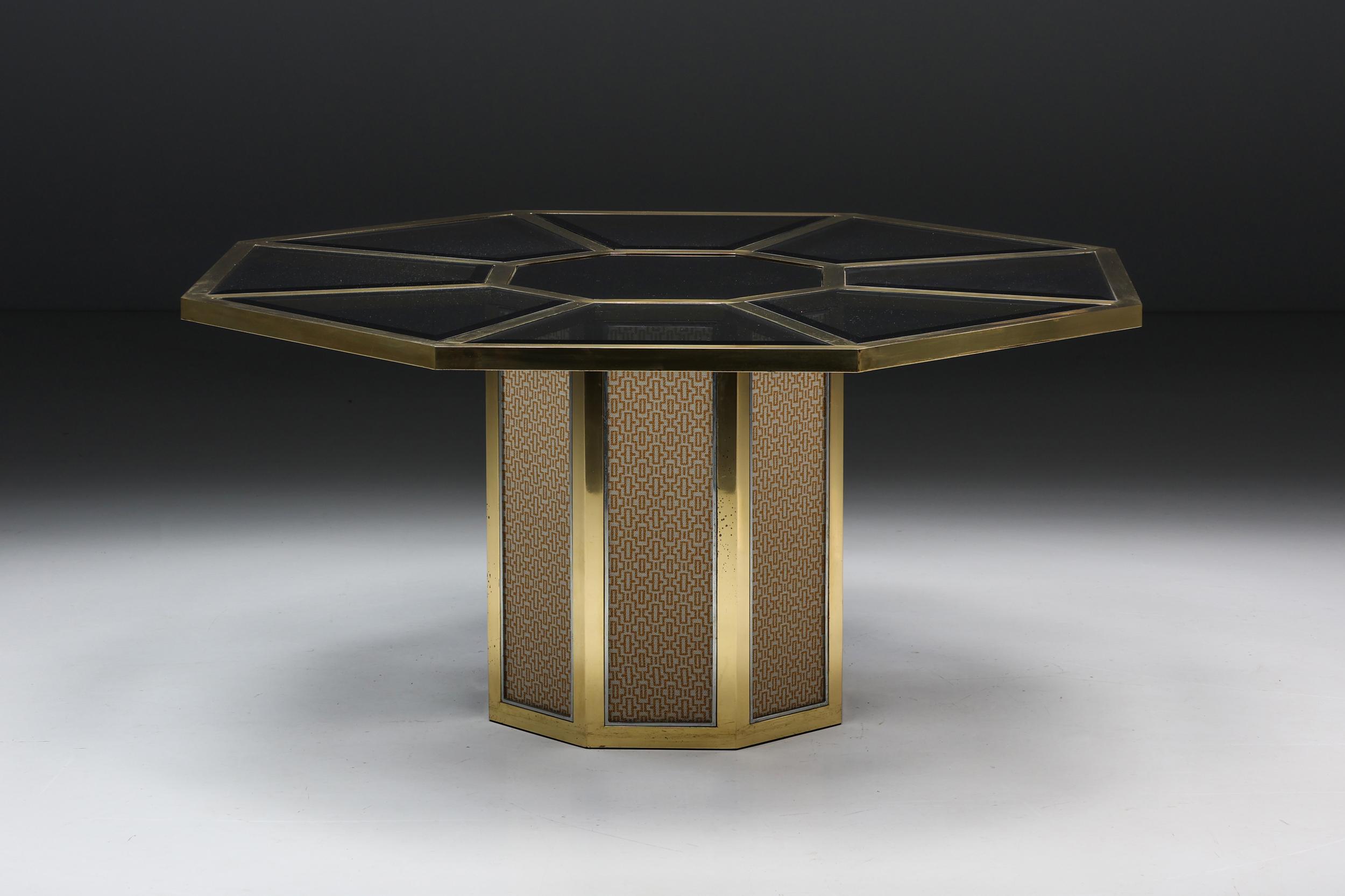 Octagonal dining table by Romeo Rega, a true gem from 1970s Italy. Crafted with precision in vintage polished brass and chrome-plated accents, this table not only showcases Rega's iconic octagonal design but also features exquisite fabric on its