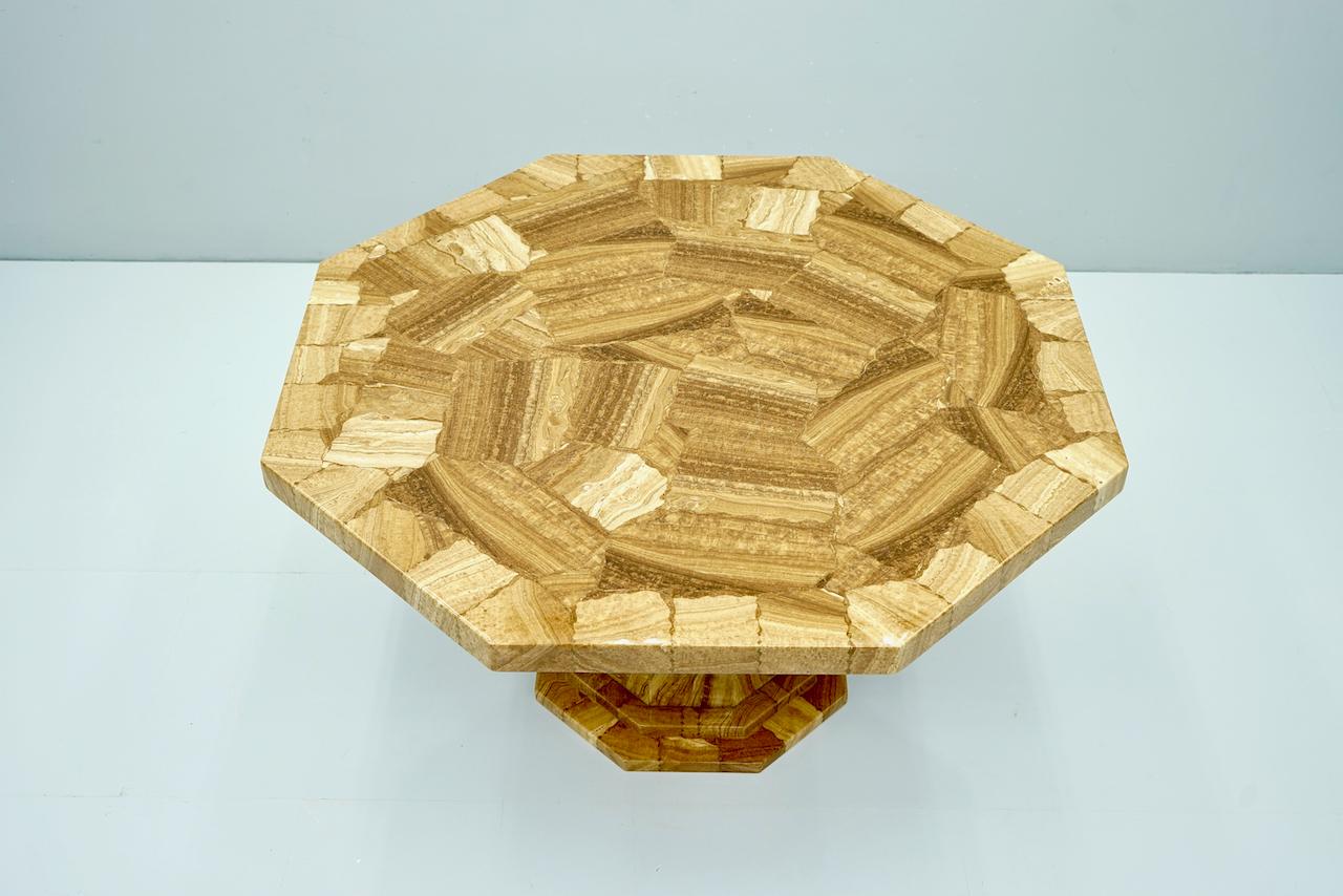 Fantastic octagonal amber colored mosaic onyx marble, lacquered with epoxid resin, on an octagonal column.
From tip to tip, the table measures 153 cm, from straight to straight side 140 cm. Height 76 cm.
The table top was newly lacquered with