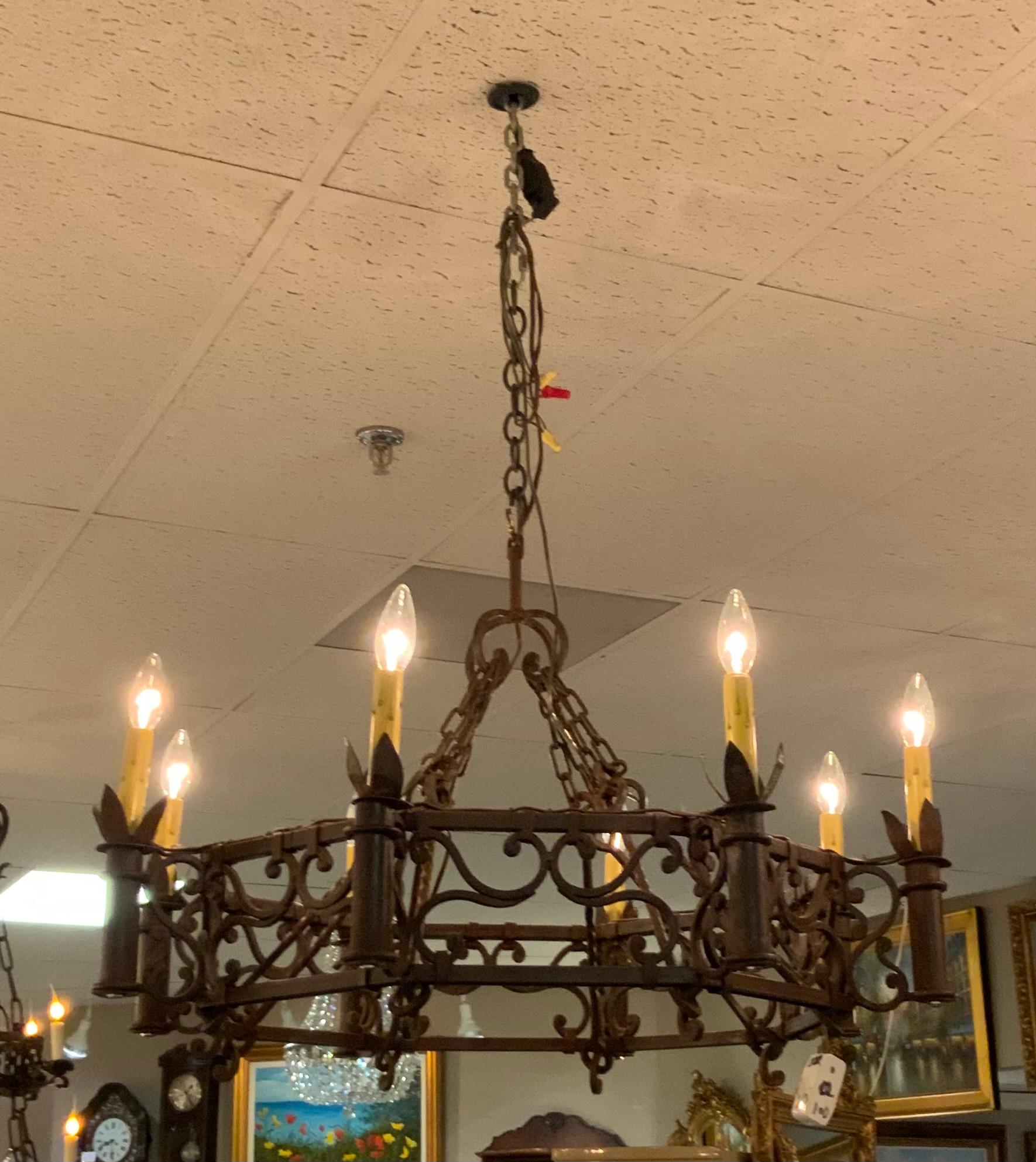 This is a fine wrought iron chandelier constructed in
Spain. The octagonal shape makes it highly desirable.
It has eight lights that circle the perimeter. Chain is attached
To the perimeter and is gathered with the other chains
Attached at the