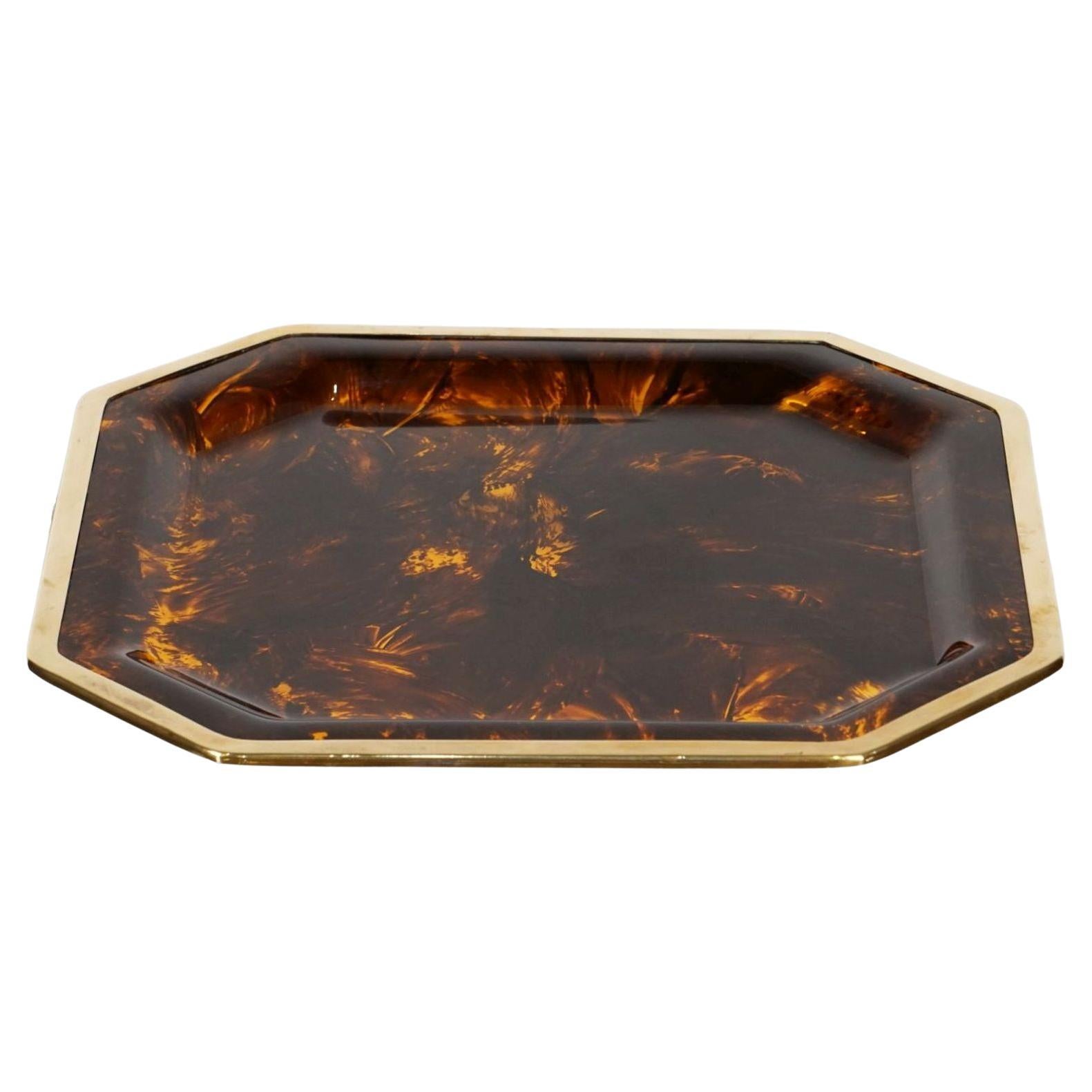 A fine large French recessed octagonal serving tray from the Mid-Century Modern period, of acrylic Lucite with a faux tortoiseshell (tortoise) pattern and gilded brass trim.

Two available - Individually priced - $1995 each tray. Measures: