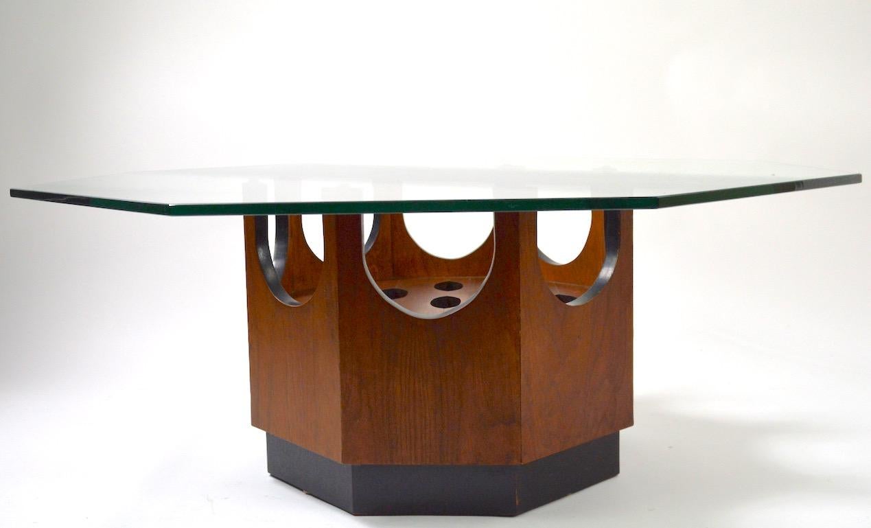Octagonal wood base with oval cut out decorations, supports the thick ( 3/8 inch ) octagonal glass top. Each side measures 38 inches. Stylish midcentury table attributed to Harvey Probber, in very good original condition, glass top has a couple of