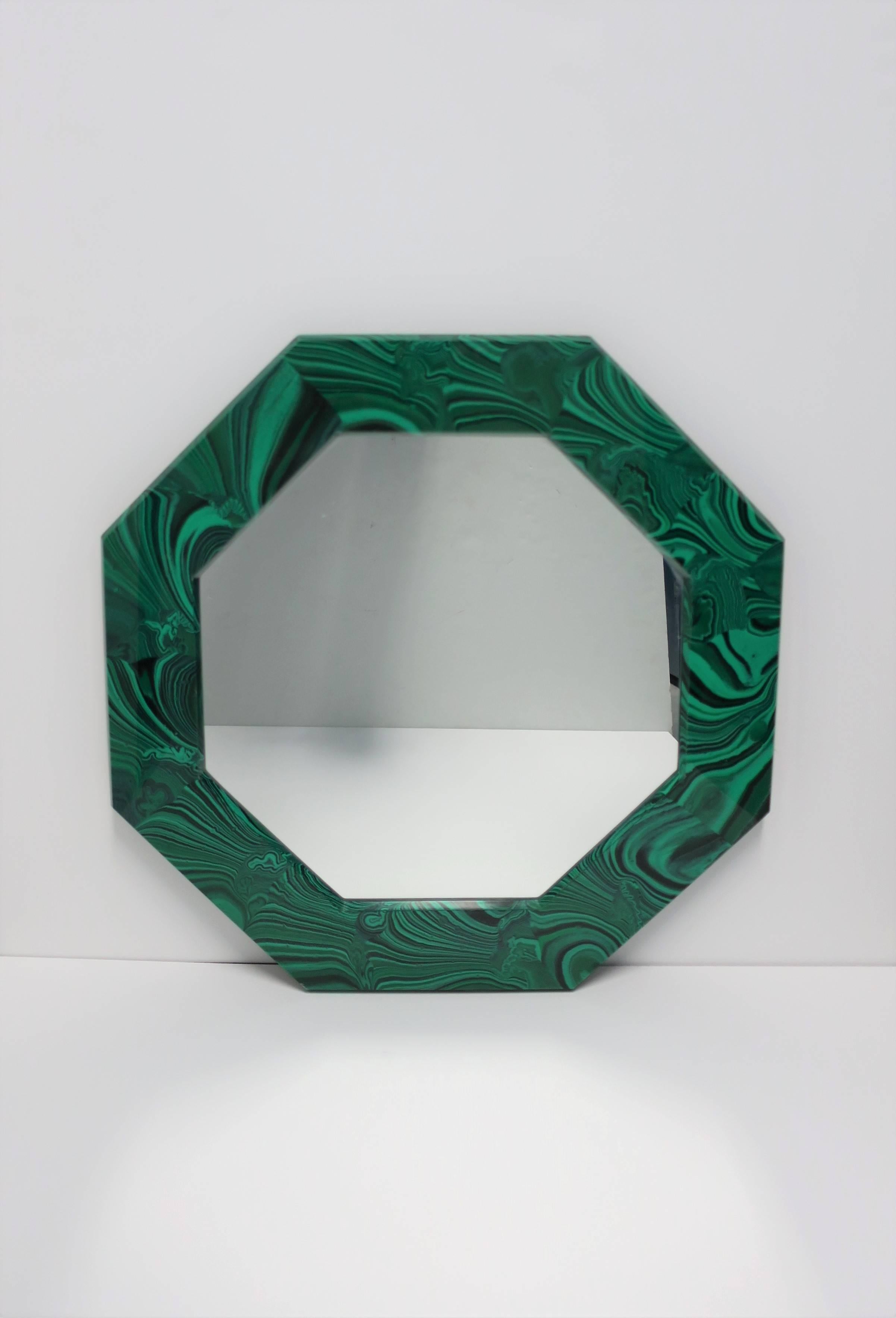 A striking octagonal green malachite resin wall mirror. Mirror can hang in two different positions as show in images #1 and #8, with appropriate hooks on back as show in images #9 and 10. Octagonal shape is a nice alternative to round, and a