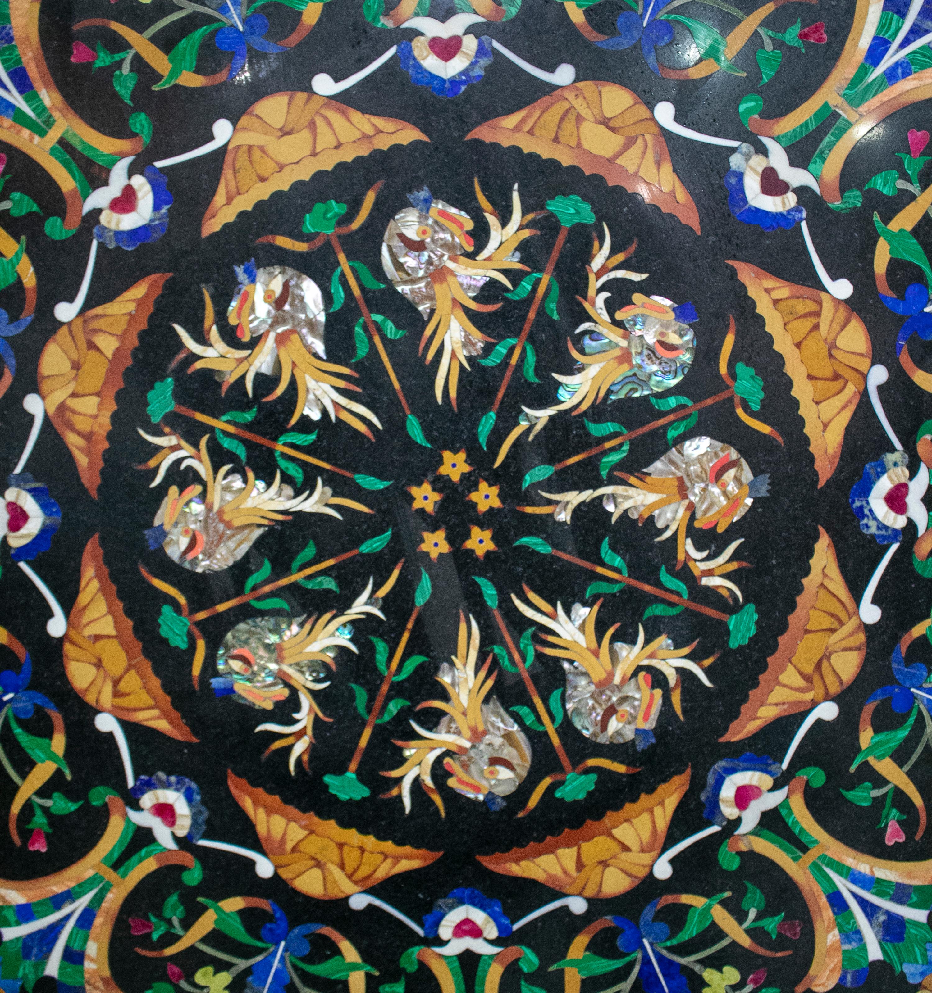 Octagonal Belgian black marble table top profusely decorated with Italian Pietre Dure mosaic inlays using green malachite, dark blue lapis, light blue turquoise, light green jade, mother of pearl and other semiprecious stones and marbles. 


 
