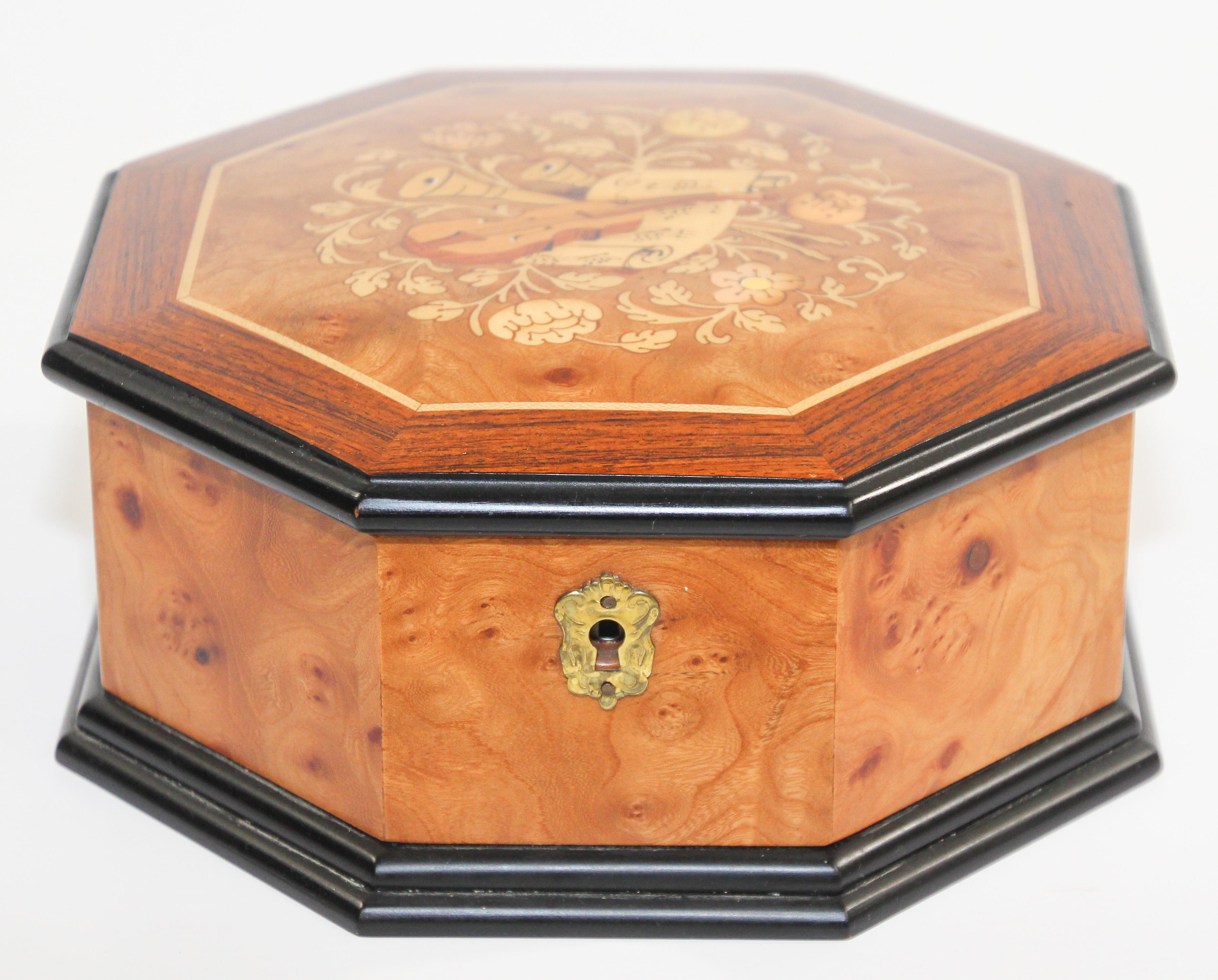 Elegant octagonal wooden music box in thuya wood.
Thuya tree is famous for rich gold and brown shades of its grain and unique exotic fragrance, similar to cedar.
Lined in brown velvet.
Hand inlaid with various precious wood top.
Upon opening, the