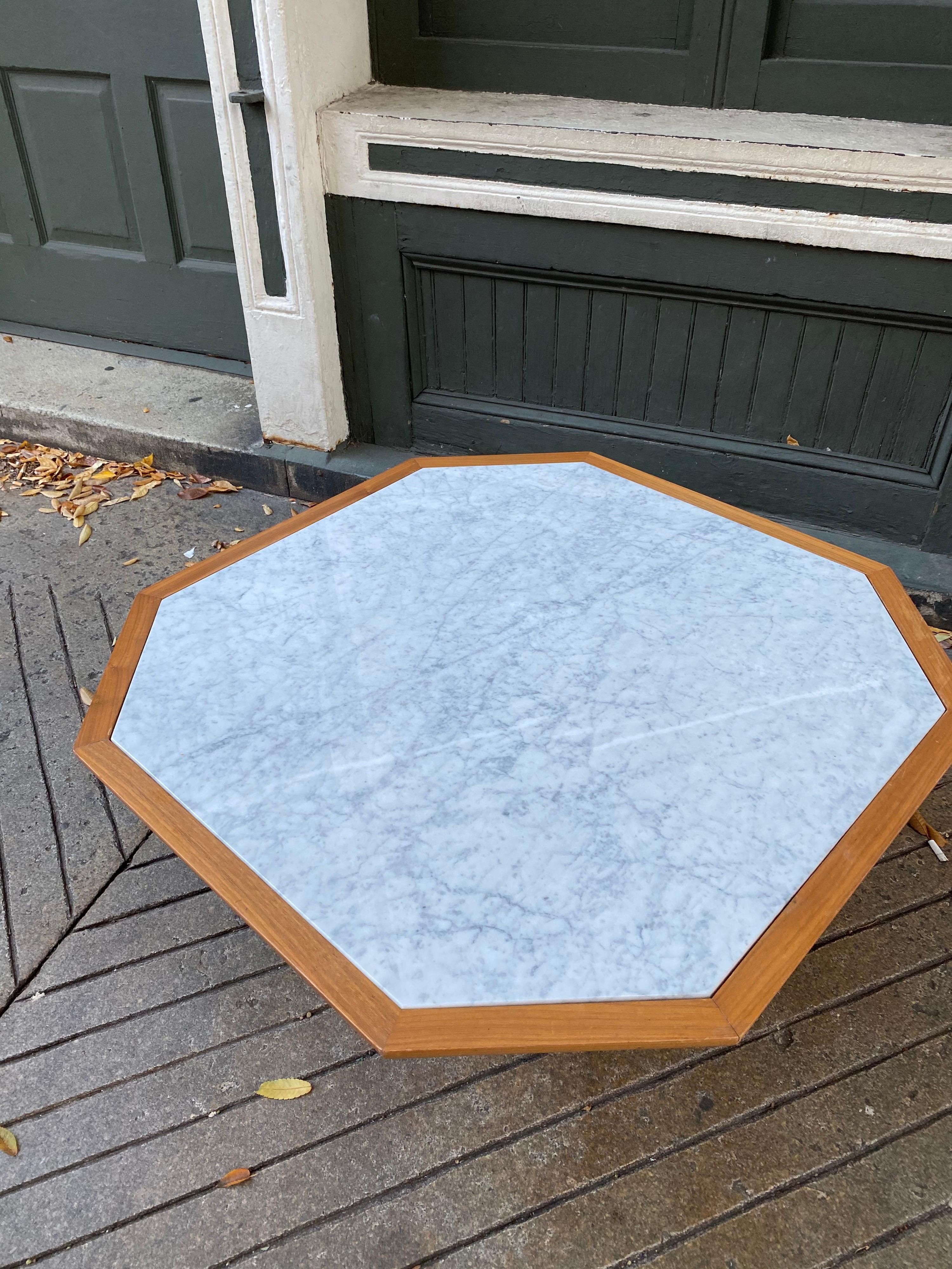 Unusual octagonal shaped marble top table. Base is made up of 10 rows of curved walnut sections forming a lattice type design. Table is amazingly made and very solid! New marble! Nice size measuring, 38