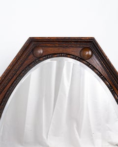 Octagonal mirror in carved oak, made in England, early 20th century.