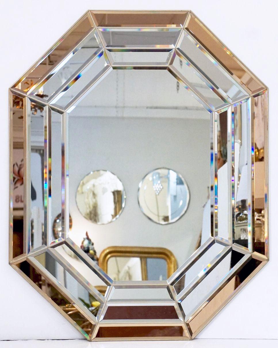A beautiful Italian Modernist octagonal mirror featuring a segmented colored and beveled glass design surrounding a clear and beveled glass interior.

Dimensions: H 45 1/4 inches x W 35 3/4 inches

Can be displayed vertically (portrait) or