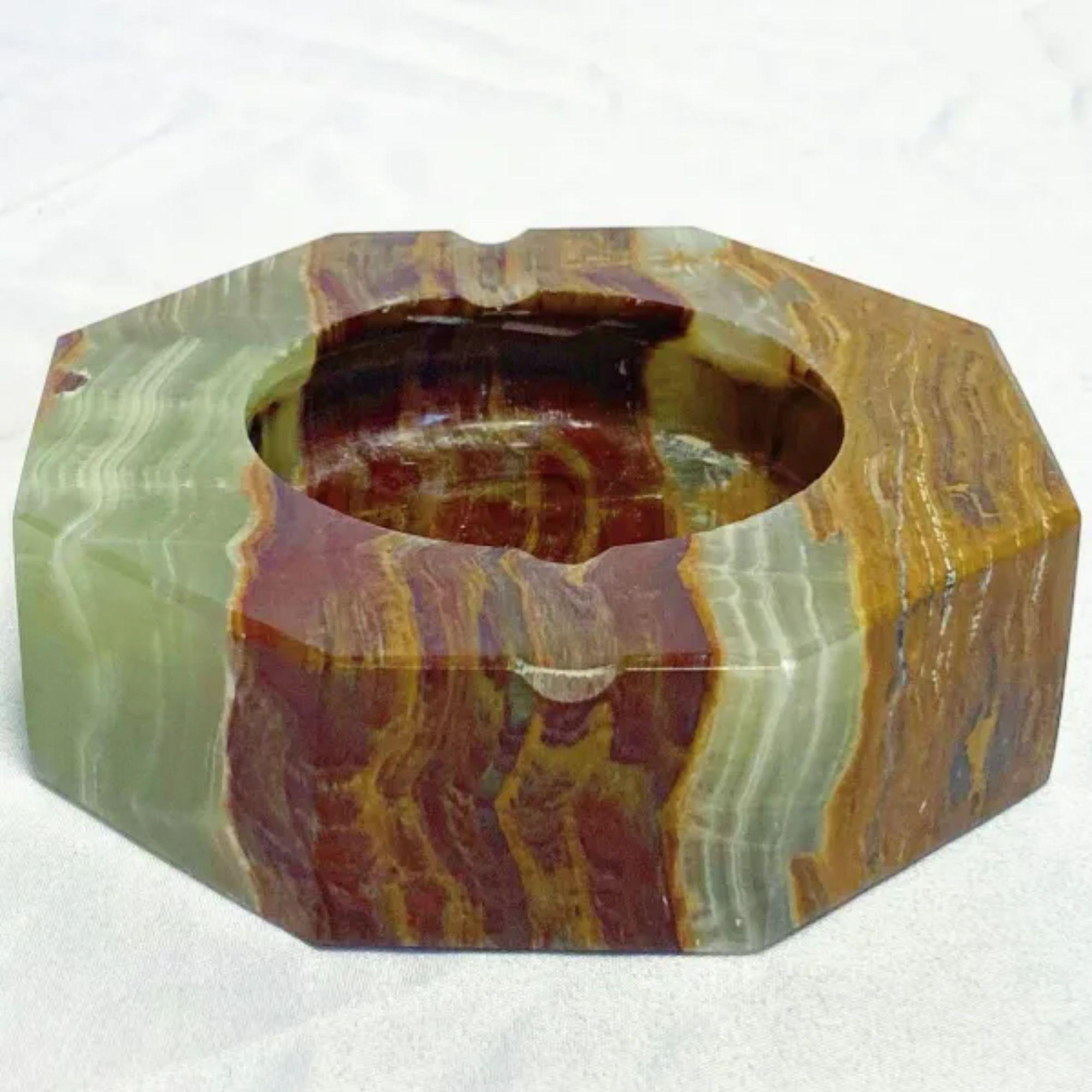 Solid Green Onyx Octagonal Ashtray in stripe colorations of green, burgundy, caramel, and brown with white veining.

Green Onyx is a symbol of purity and restfulness. It has the power to relieve you of your worries, fears, tension, and stress. Its