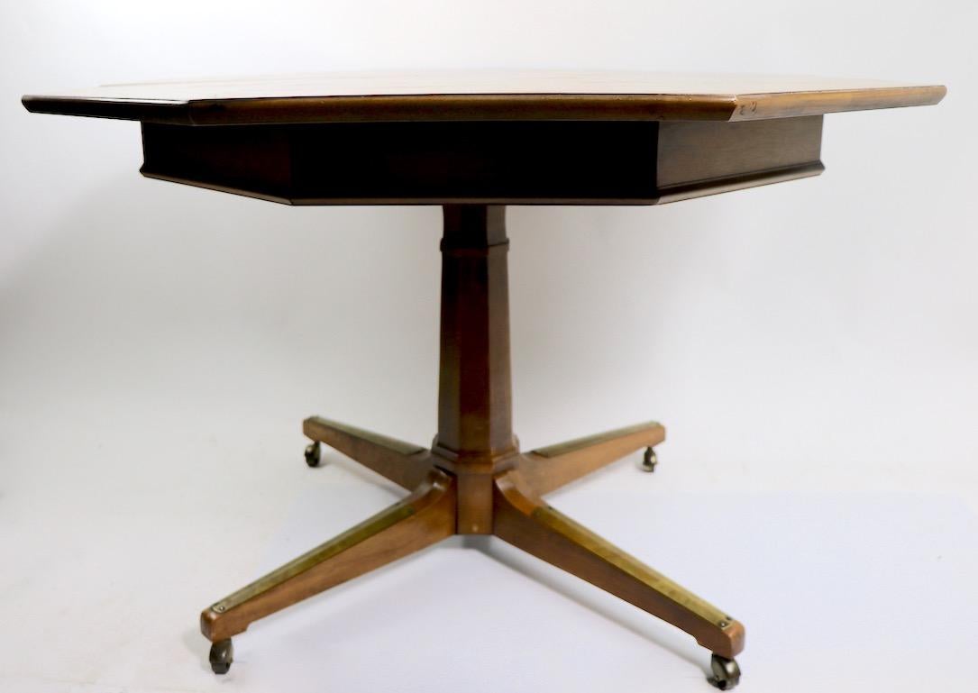 Stylish and well made pedestal dining table having an octagonal top and two large leaves (18 inch each). The table is in very clean, original condition. As is often seen, the leaves are darker than the table top, as the leaves were stored in a
