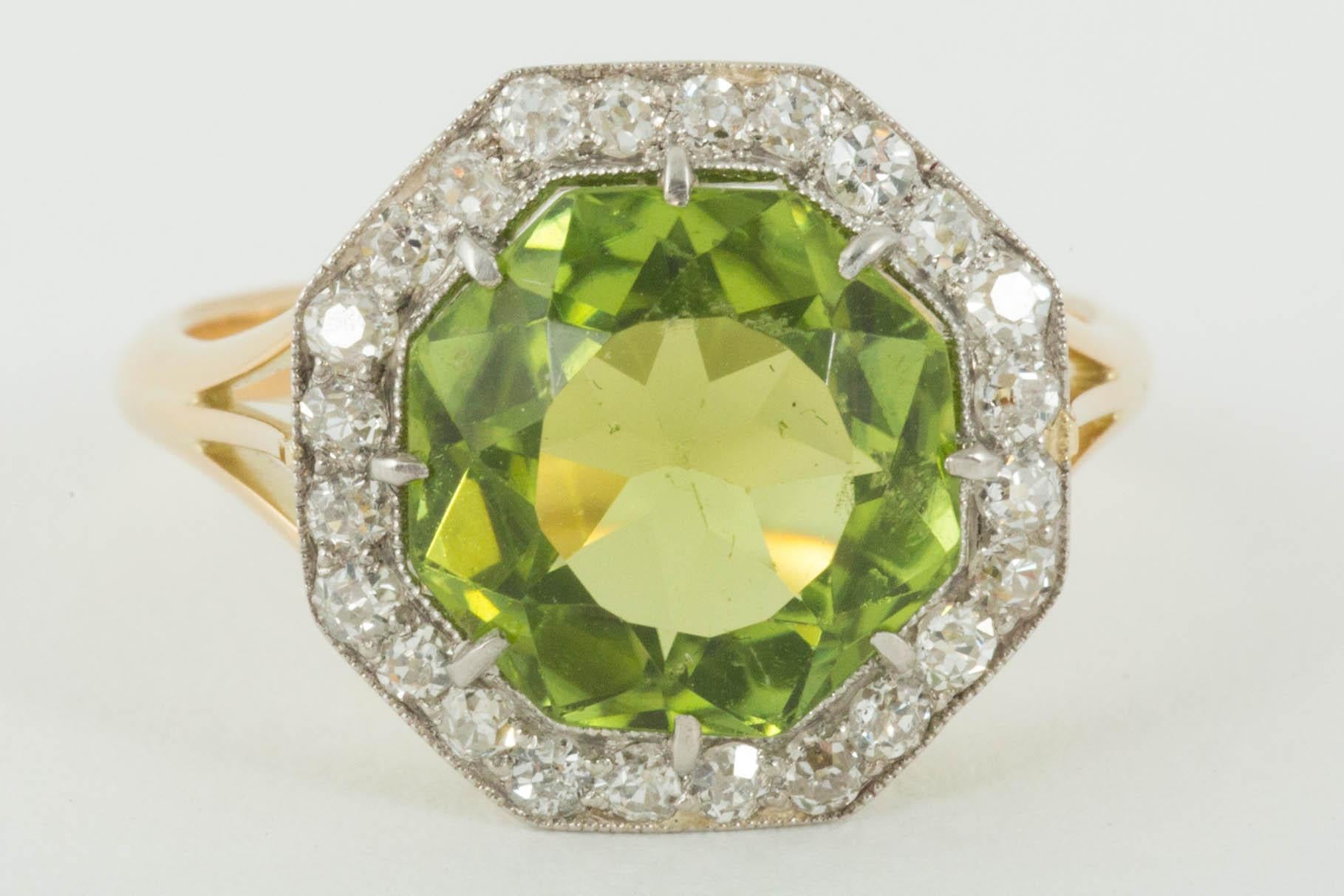 Peridot surrounded by Diamond border set in 18ct Gold and Platinum
Finger size N 1/2
