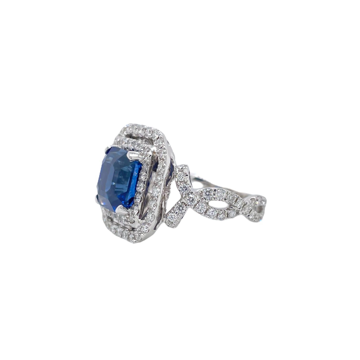 Ring contains one GIA certified octagonal shape sapphire 4.60ct and round brilliant diamonds within halo and infinity mounting 1.58tcw. Sapphire and diamonds are mounted in a handmade basket prong setting. Sapphire originates from Madagascar.